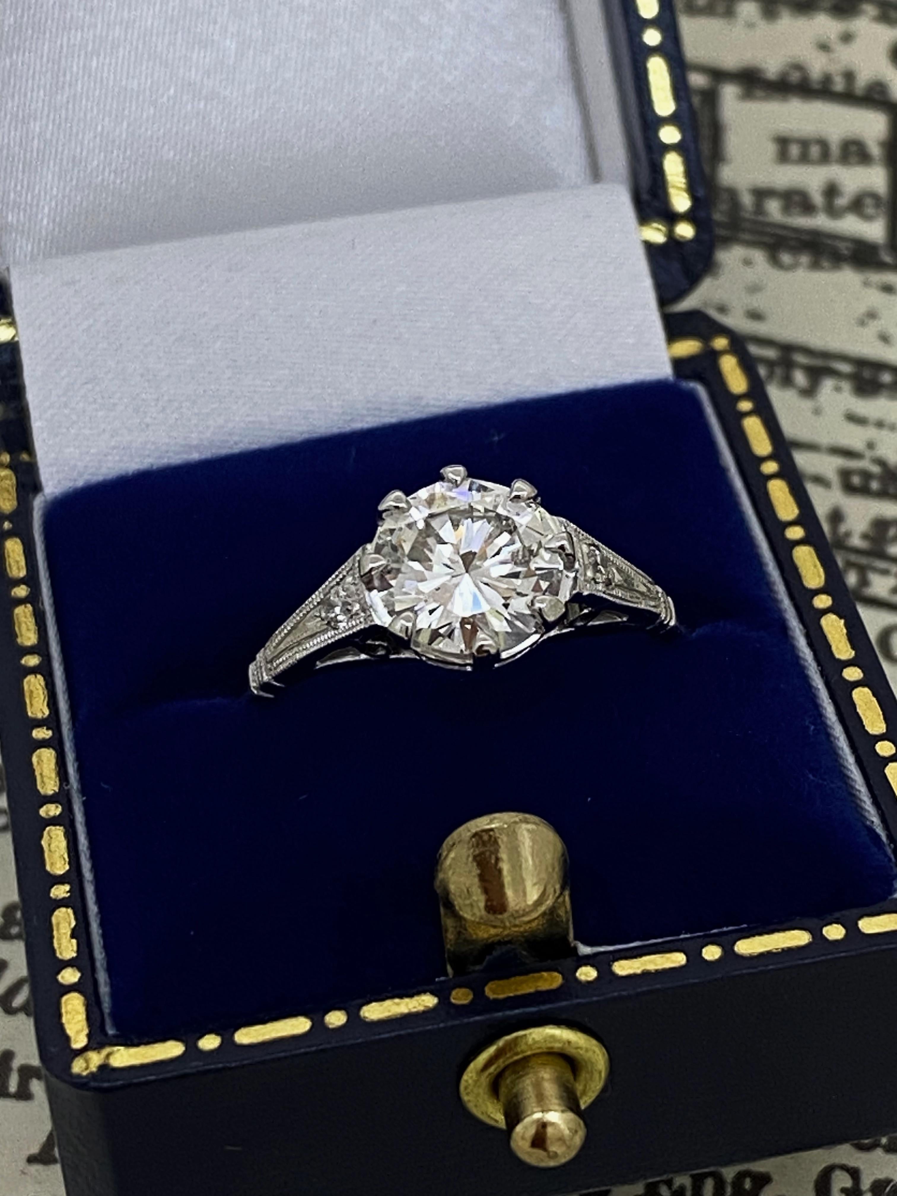 Of timeless & visually striking solitaire with accents design, 
this retro handmade piece is centrally 6-claw set with 
Natural Round Brilliant Cut Diamond
of impressive size – 1.33ct (7.34 – 7.40mm x 4.15mm) 
of F colour, VS1 clarity & sun-like