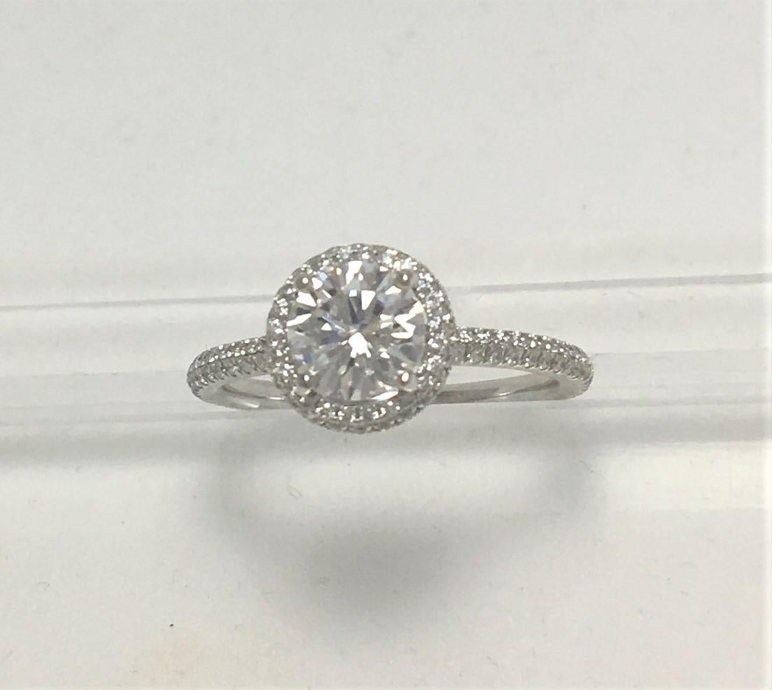 Classic round center diamond with bezel set diamonds on band makes this ring perfect for any bride!
1.34 total diamond weight
.94 Carat Round G-H VS Diamond
Approximately .40 carat total weight diamonds on shank and in halo around center diamond
18K