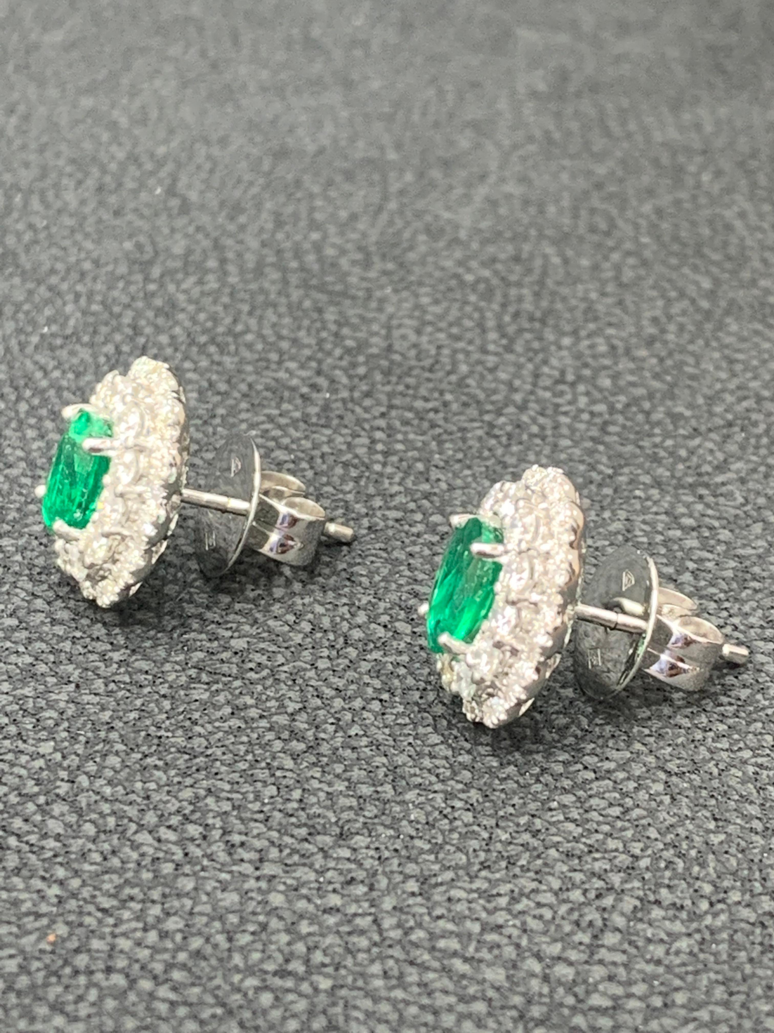 Showcasing two color-rich oval cut emeralds weighing 1.34 carats total, surrounded by a double row of round brilliant diamonds. 96 Accent diamonds weigh 1.05 carats total. Set in 18 karats white gold.

Style available in different price ranges.