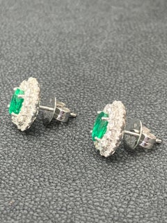 1.34 Carat Oval Cut Emerald and Diamond Halo Stud Earrings in 18K White Gold