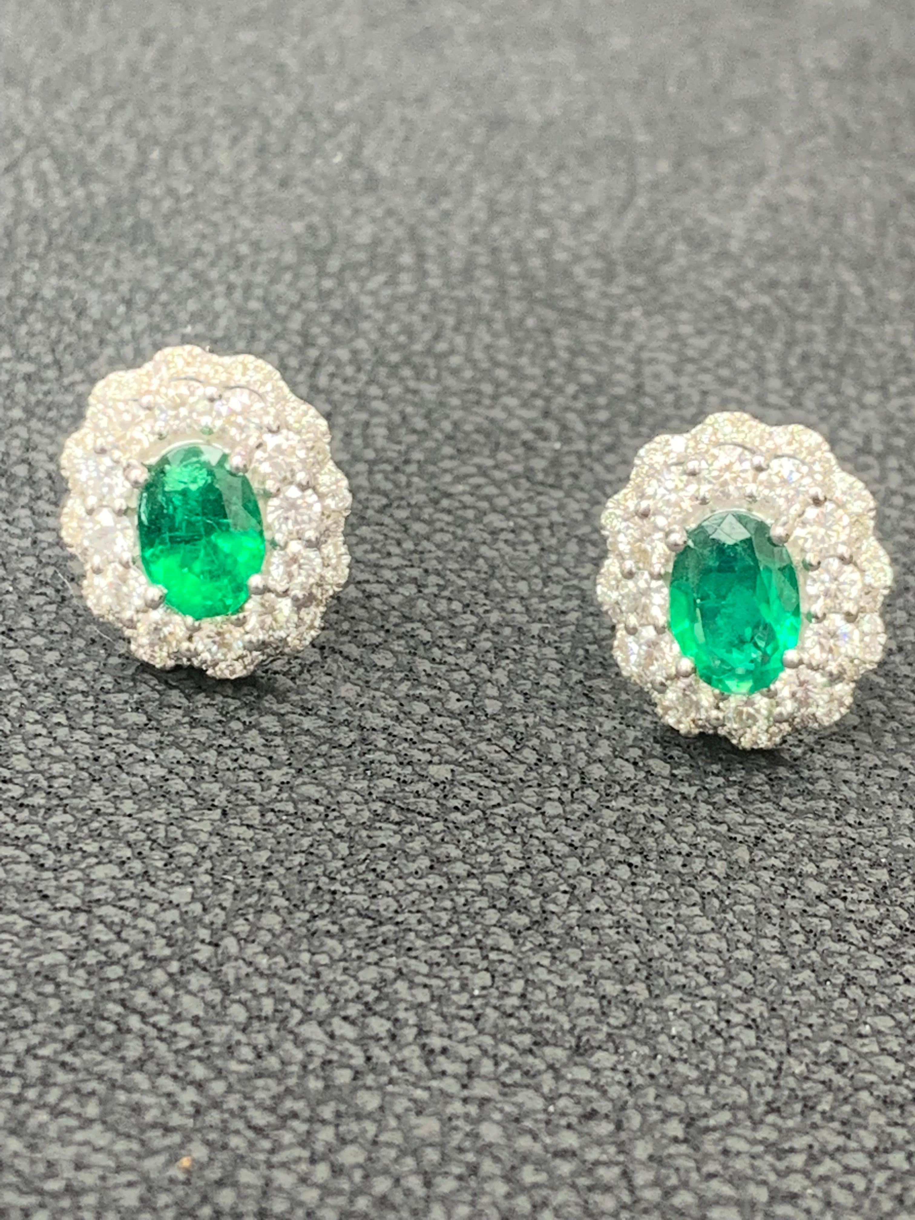 1.34 Carat Oval Cut Emerald and Diamond Halo Stud Earrings in 18K White Gold In New Condition For Sale In NEW YORK, NY
