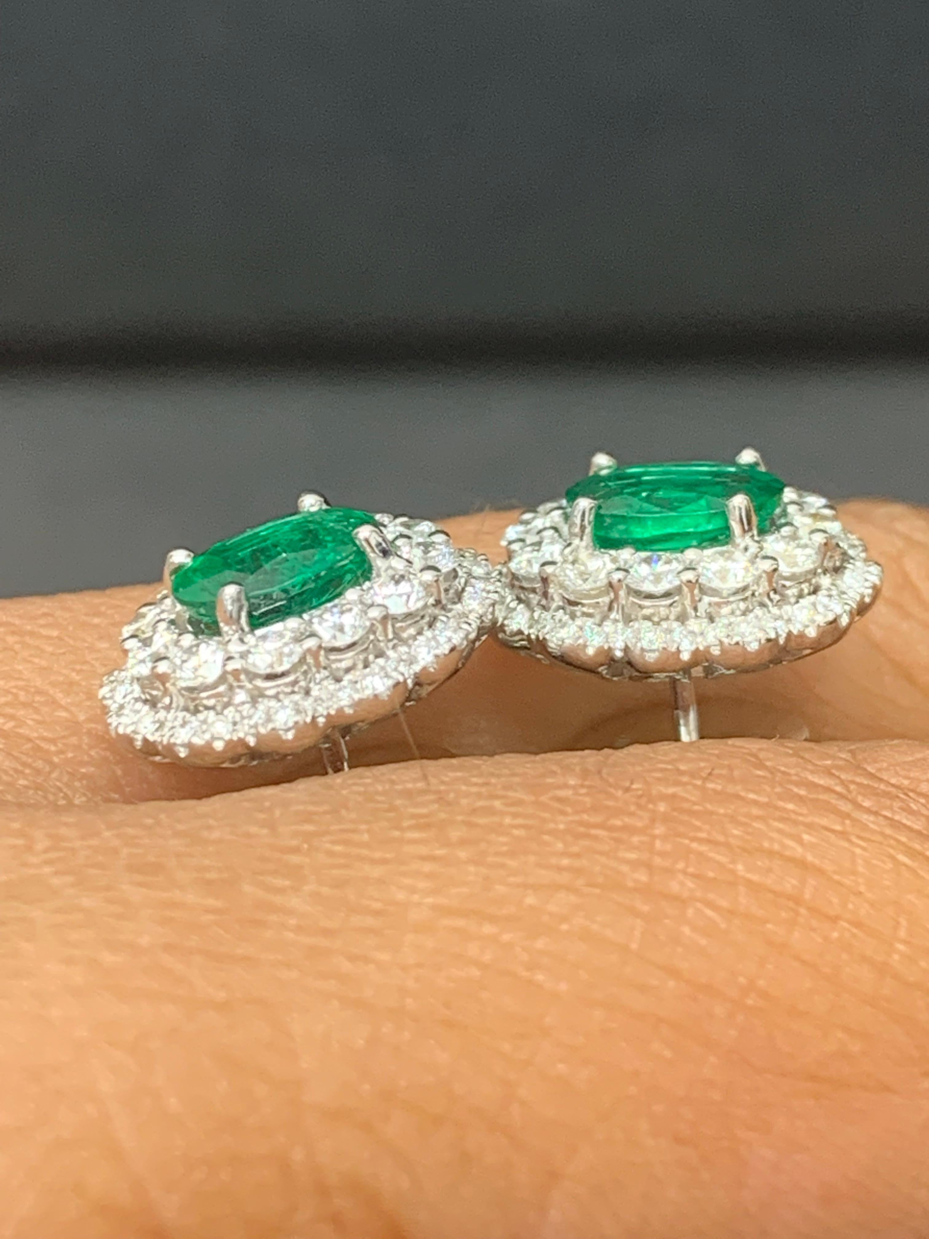 1.34 Carat Oval Cut Emerald and Diamond Halo Stud Earrings in 18K White Gold For Sale 2