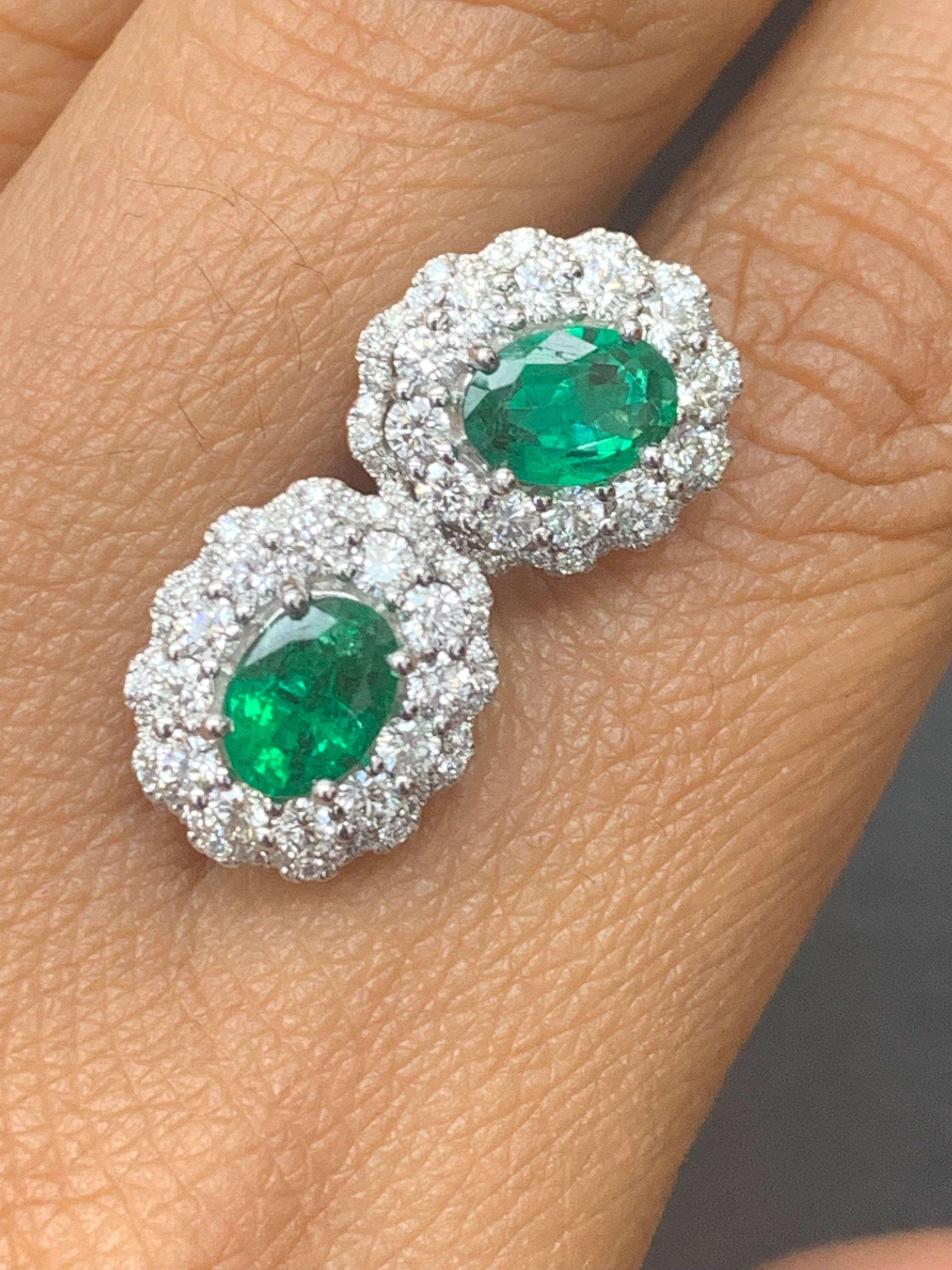 1.34 Carat Oval Cut Emerald and Diamond Halo Stud Earrings in 18K White Gold For Sale 4