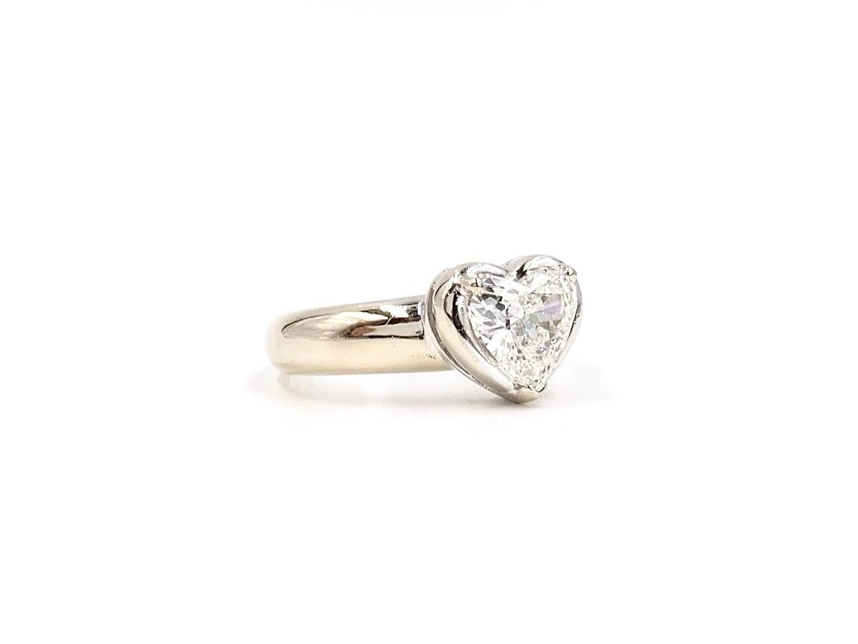 Made in 14 karat white gold, a 1.34 carat heart cut diamond sits beautifully in a three prong setting atop a 4.5mm wide shank. Heart diamond has a very good make that shows it's carat weight well. Approximate color and clarity is H, SI1 (near