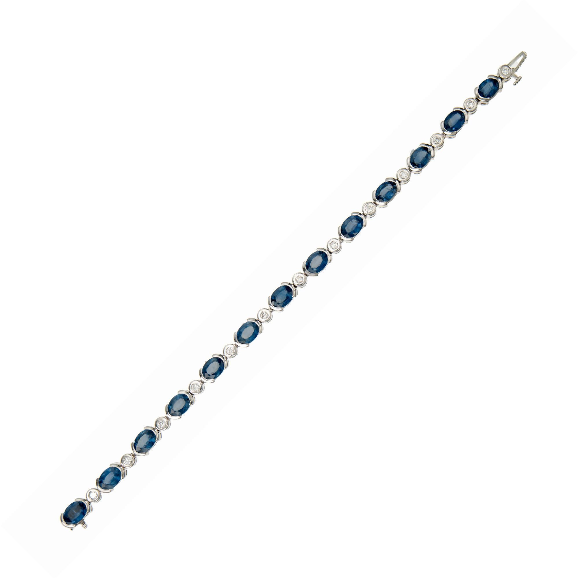 Bright semi bezel set oval cornflower blue sapphires and diamond link bracelet. The 13 oval sapphires have an approx. carat weight of 13.00cts. They are separated by 13 bright white full cut tube set diamonds with a total carat weight of .45cts.