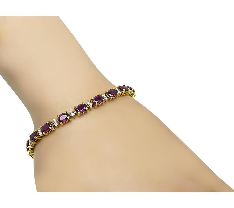 This is a gorgeous 18k yellow gold bracelet. The bracelet is set with lovely oval cut rubies that weigh approximately 13.41ct. The rubies are accentuated by sparkling round cut diamonds that weigh approximately 0.80ct. The color of these diamonds is