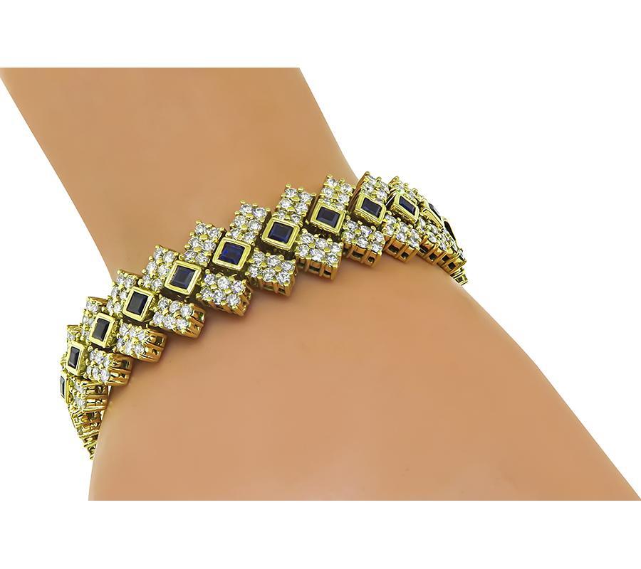 This is an amazing 18k yellow gold bracelet. The bracelet is set with sparkling round cut diamonds that weigh approximately 13.44ct. The color of these diamonds is H with VS1 clarity. The diamonds are accentuated by lovely square cut sapphires that