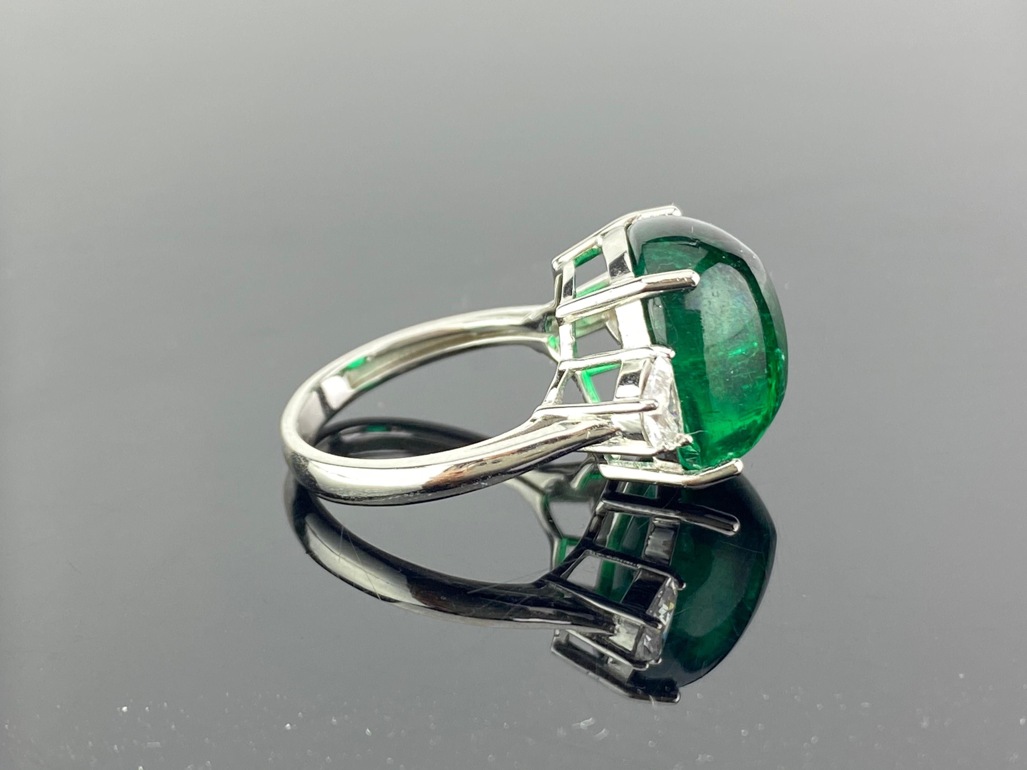 A unique 13.47 carat sugarloaf Zambian Emerald,  three stone engagement ring, with 2 half-moon side stone diamonds. The emerald is of great lustre and has an ideal colour. All set in 18K white gold. Currently a ring size US 6.5, but we can resize