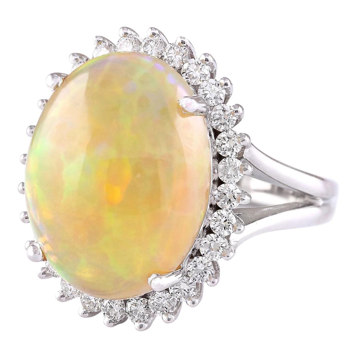 Introducing our enchanting 13.48 Carat Opal 14 Karat White Gold Diamond Ring. Crafted from stamped 14K White Gold, this ring weighs 14.8 grams, ensuring both quality and durability. The focal point is a breathtaking opal gemstone weighing 12.48