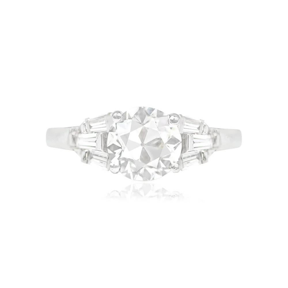 This platinum ring features a mesmerizing 1.34-carat old European cut diamond at its center, J color and VS1 clarity, which is securely set in prongs. Enhancing its allure, three staggered baguette-cut diamonds on each shoulder frame the center