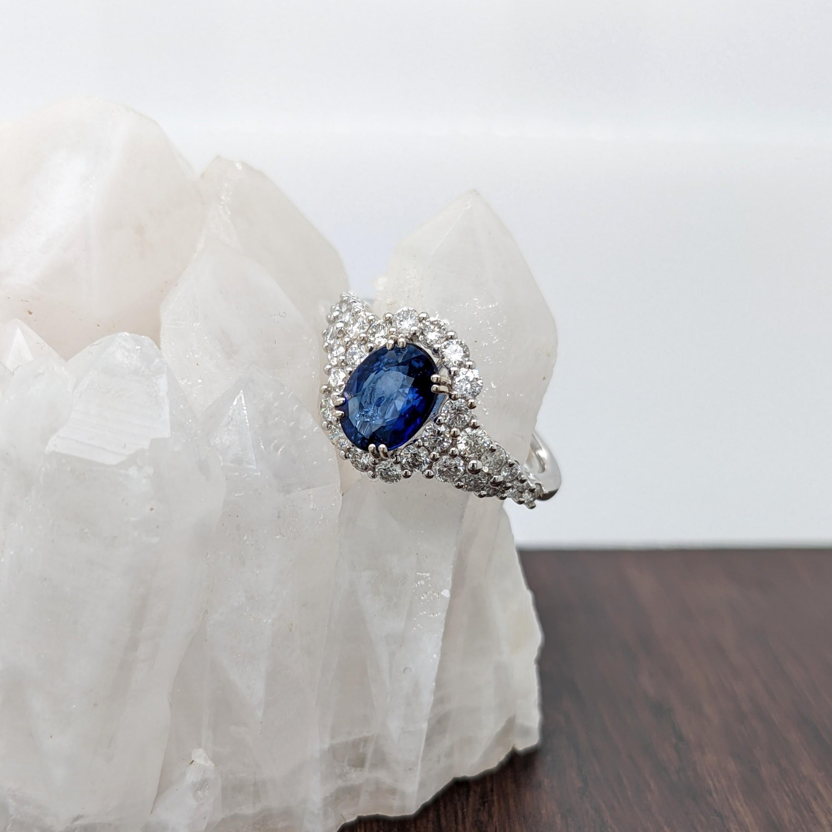 This ring design is a tried and tested NNJ Designs favorite! Featuring a gorgeous Ceylon blue sapphire with a stunning diamond halo and accented shank that elevates this ring to a gorgeous statement piece, all set in solid 14k white gold.

Item