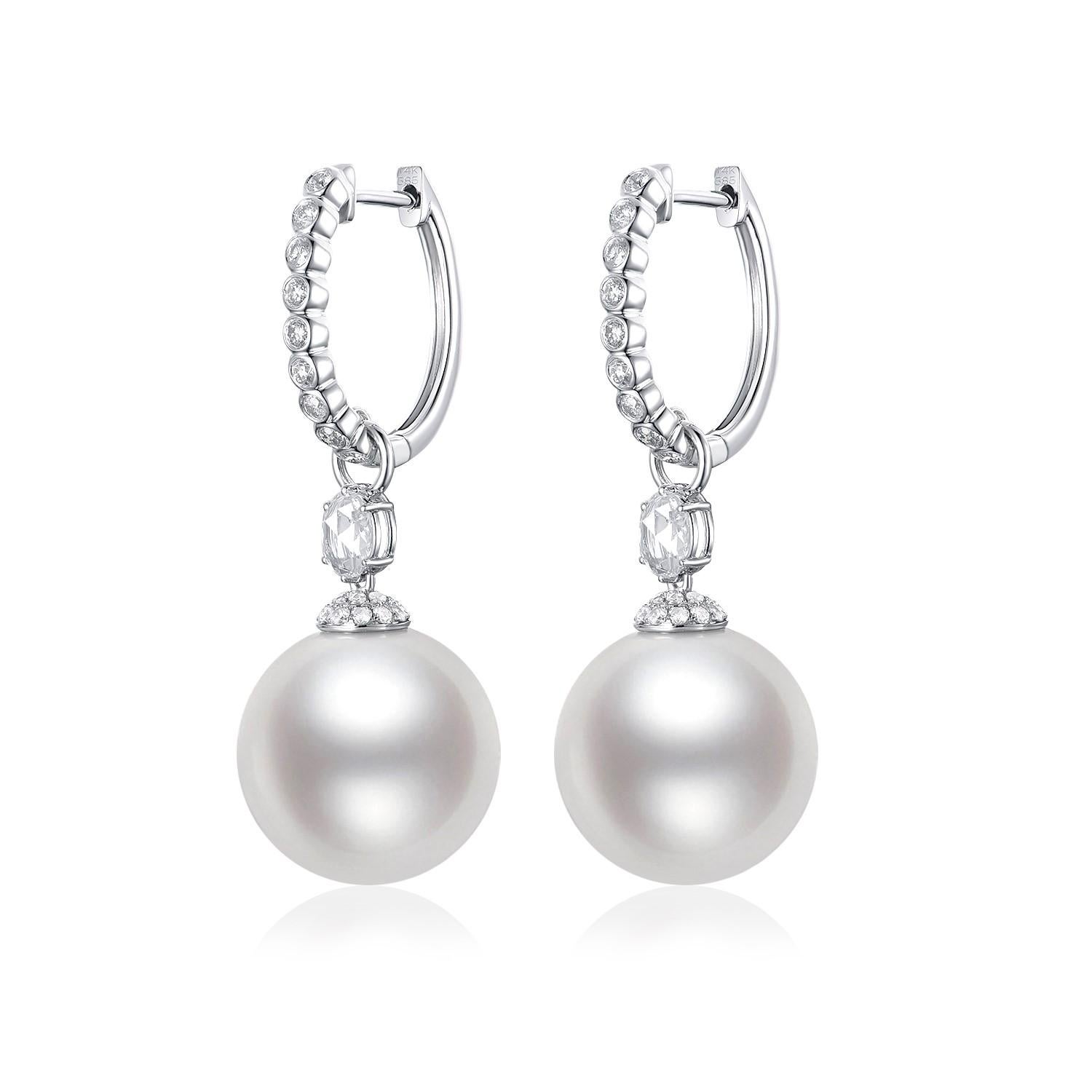 Featured here are elegant drop earrings, beautifully crafted in 14K white gold. Each earring is adorned with a lustrous 13.4mm South Sea pearl, renowned for its size and the warm, natural sheen that radiates sophistication. Above the pearls, rose
