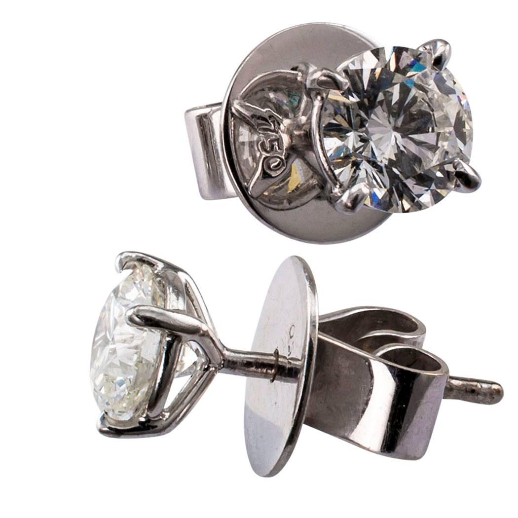 Diamond stud 1.35 carat total weight earrings. Featuring a pair of very well matched, round brilliant-cut diamonds totaling approximately 1.35 carats, approximately H color and SI2 clarity, mounted in 18-karat white gold with larger, high quality,
