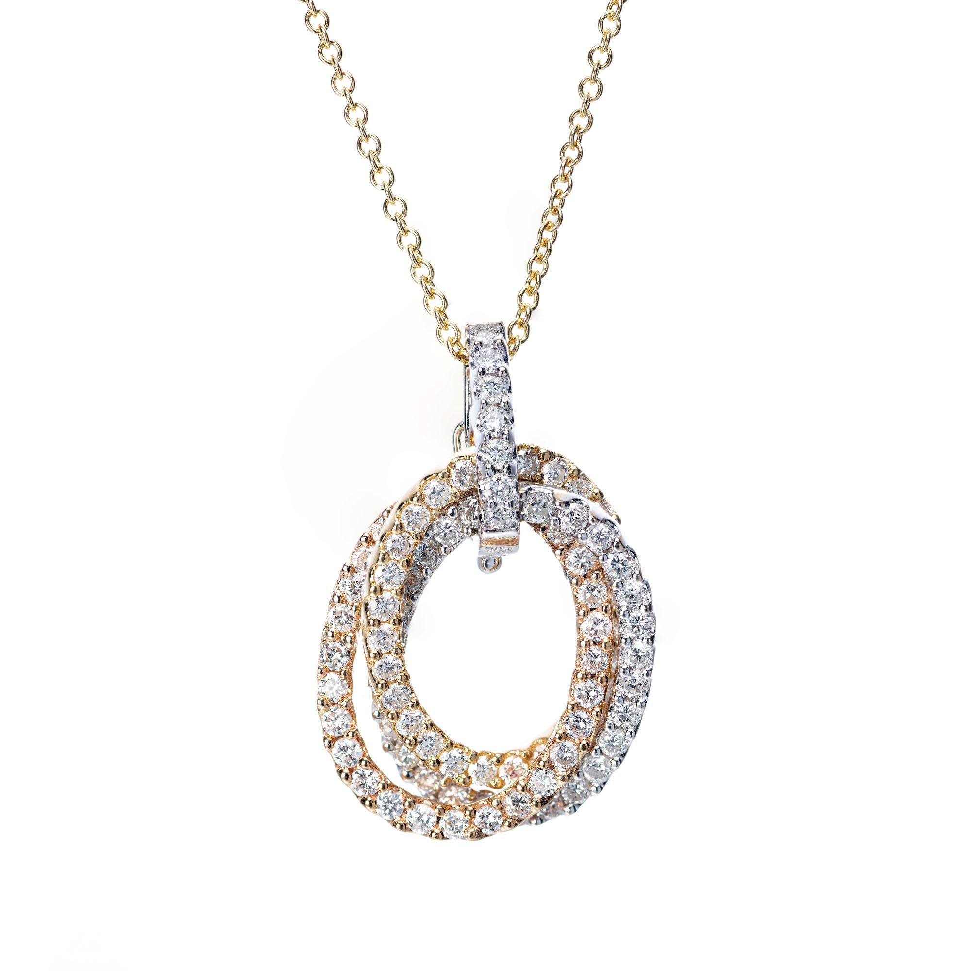 Tri color 18k yellow, white and rose gold oval interlocking rings set with 1.35 carats of bright white diamonds. 19 inch chain.

91 brilliant round cut diamonds, F-G SI-I, approx. 1.35cts
18k yellow gold 
18k white gold
18k rose gold
Stamped: 750