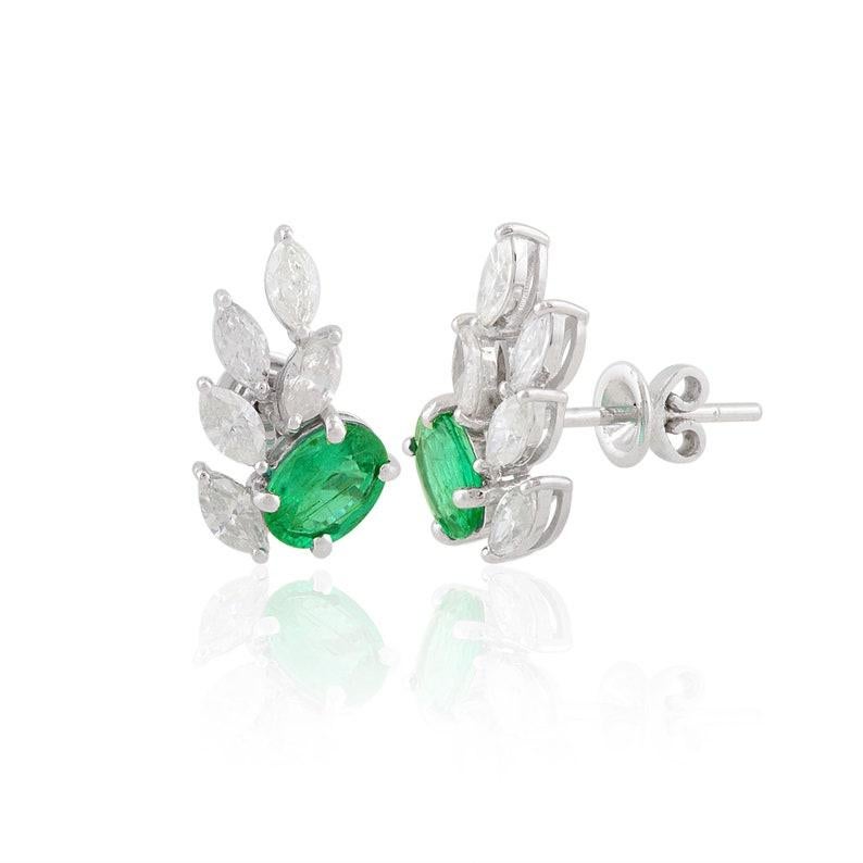 Cast in 10 karat gold, these stud earrings are hand set with 1.35 carats emerald and 1.25 carats of glimmering diamonds. 

FOLLOW MEGHNA JEWELS storefront to view the latest collection & exclusive pieces. Meghna Jewels is proudly rated as a Top