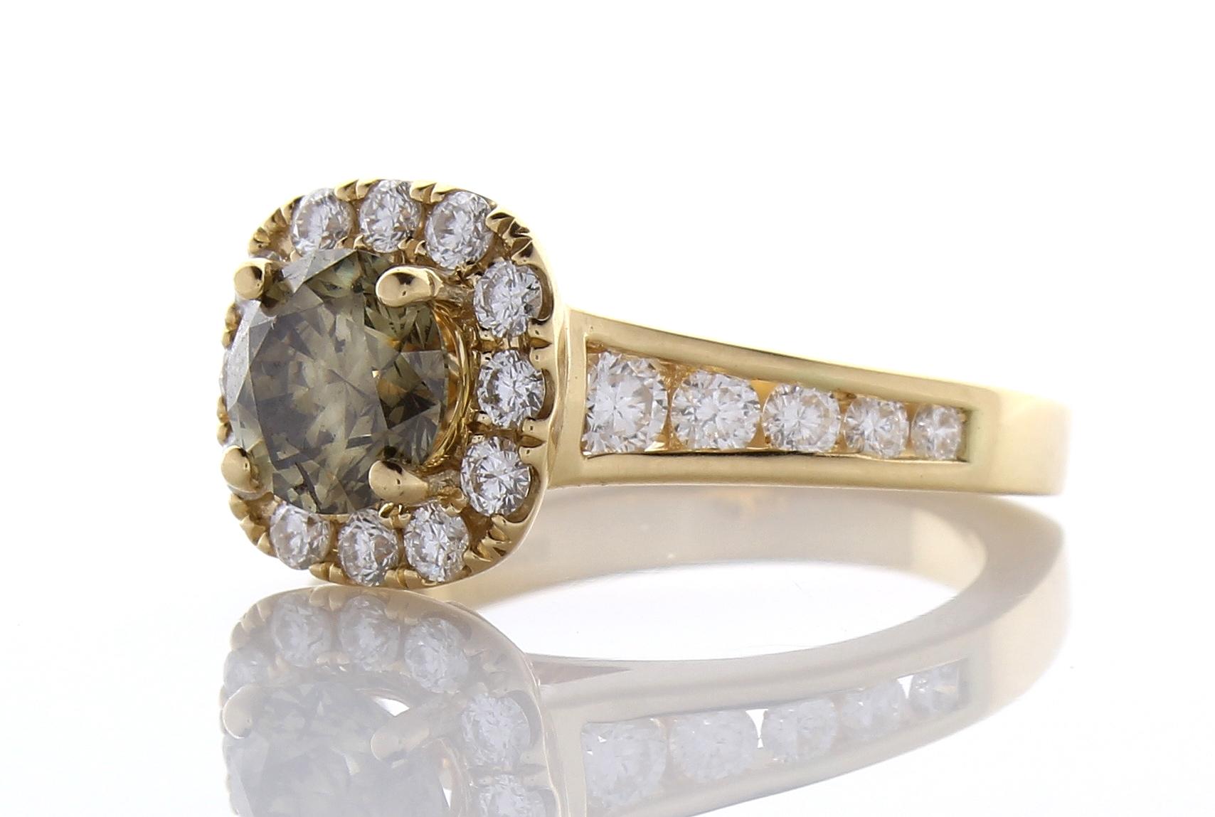 This incredible custom made halo engagement ring features a generous display of diamonds and color. One round brilliant cut fancy dark greenish-yellow-brown diamond is prong set in the center with a weight of 1.35 carats. This center stone is