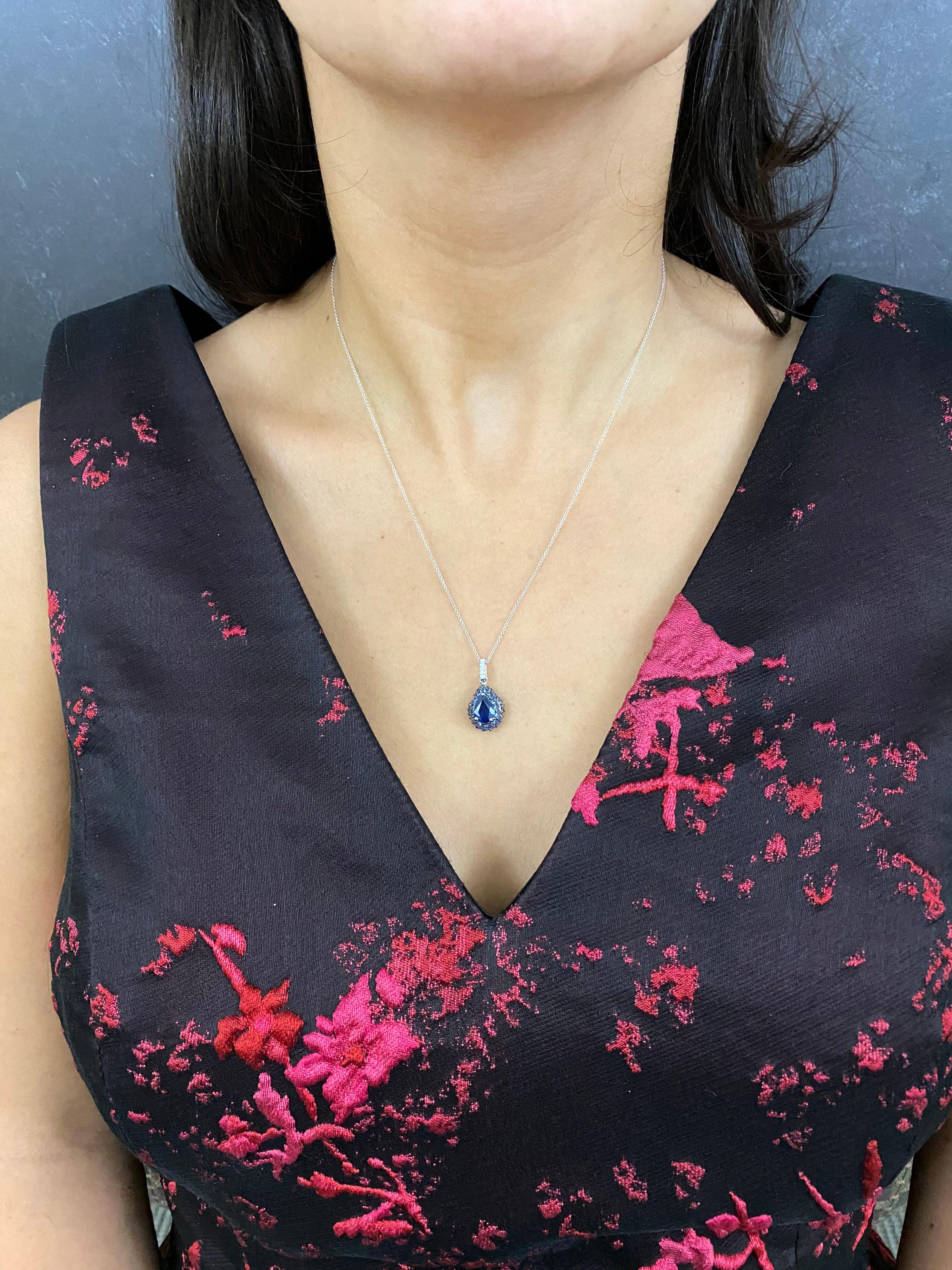 Material: 18K White Gold 
Main Stone Details: 1 Pear Shaped Sapphire at 1.35 Carats - Measuring 8 x 6mm
Stone Details: 31 Round Blue Sapphires at 1.00 Carats
Diamond Details: 5 Round White Diamonds at 0.02 Carats. Clarity/ SI : Color H-I

Fine