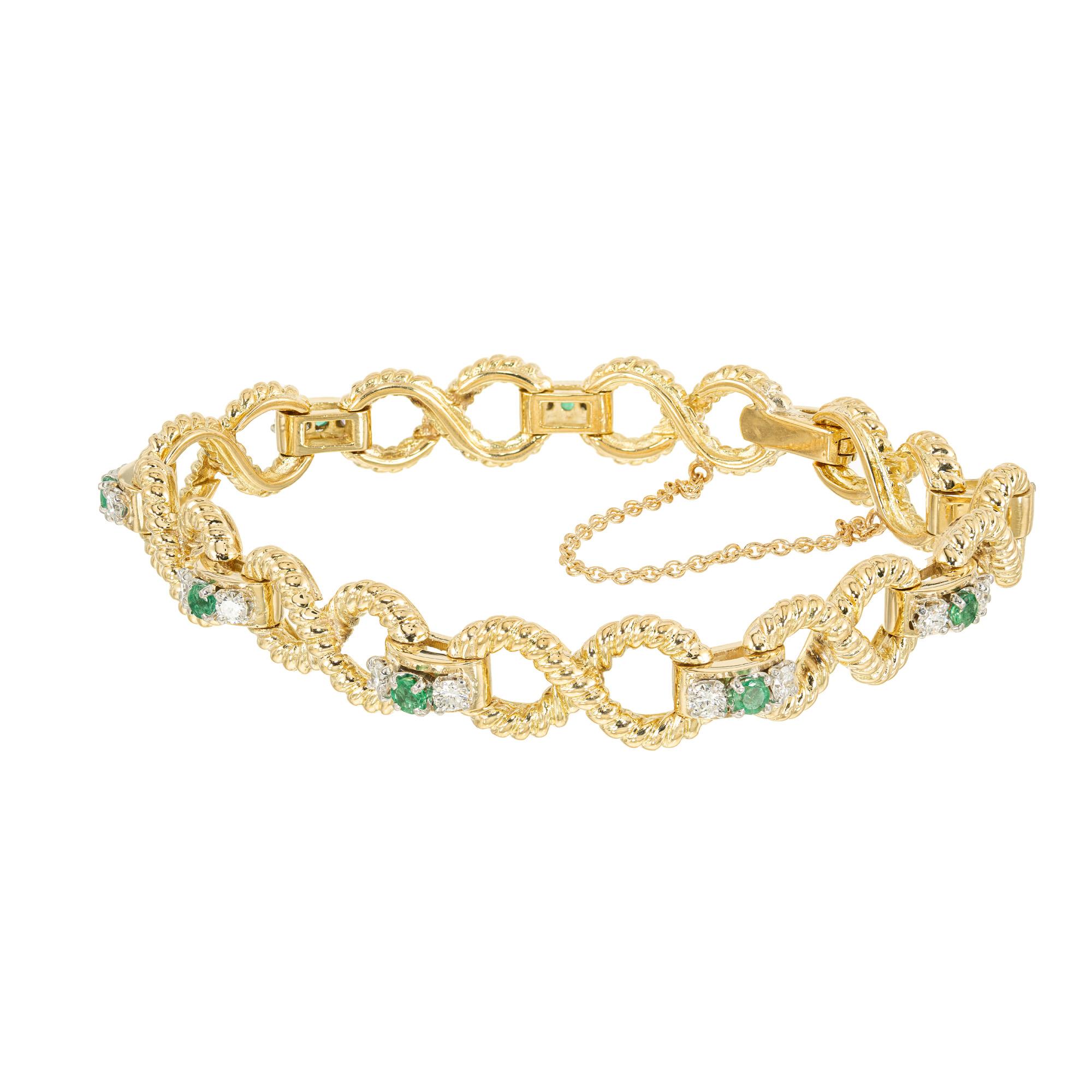 This stunning bracelet is designed to make a statement. This piece starts with sold 14k yellow gold figure eight, twisted wire links which are connected by 9 vibrant round emeralds that are surrounded by 18 round cut sparkling diamonds which
