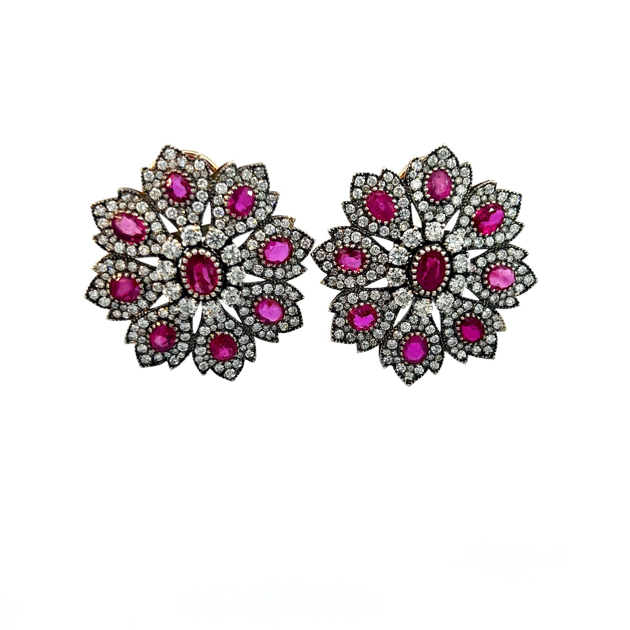 The earrings are a captivating creation featuring 13.5 carats of oval-cut rubies in a striking red hue. Accentuated by 8.3 carats of round-cut white diamonds, these earrings exhibit a clarity of VS2 and a color grade of F. Crafted from 18k gold, the