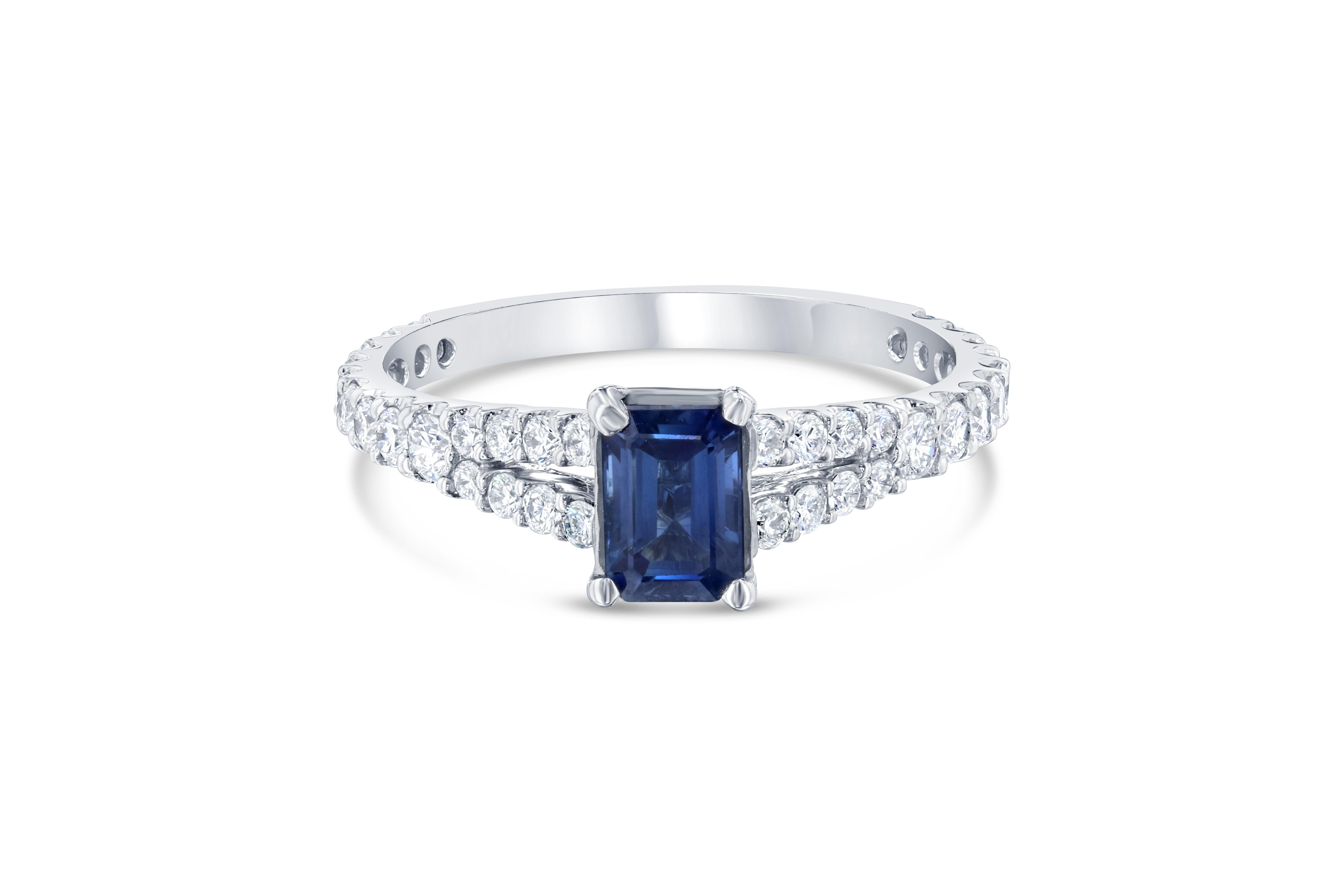 This delicate and dainty beauty has an Emerald Cut Blue Sapphire that weighs 0.79 Carats. It has 36 Round Cut Diamonds that weigh 0.56 Carats. The clarity and color of the diamonds are VS-H. The Emerald Cut Sapphire measures at 6 mm x 4 mm. 

It is
