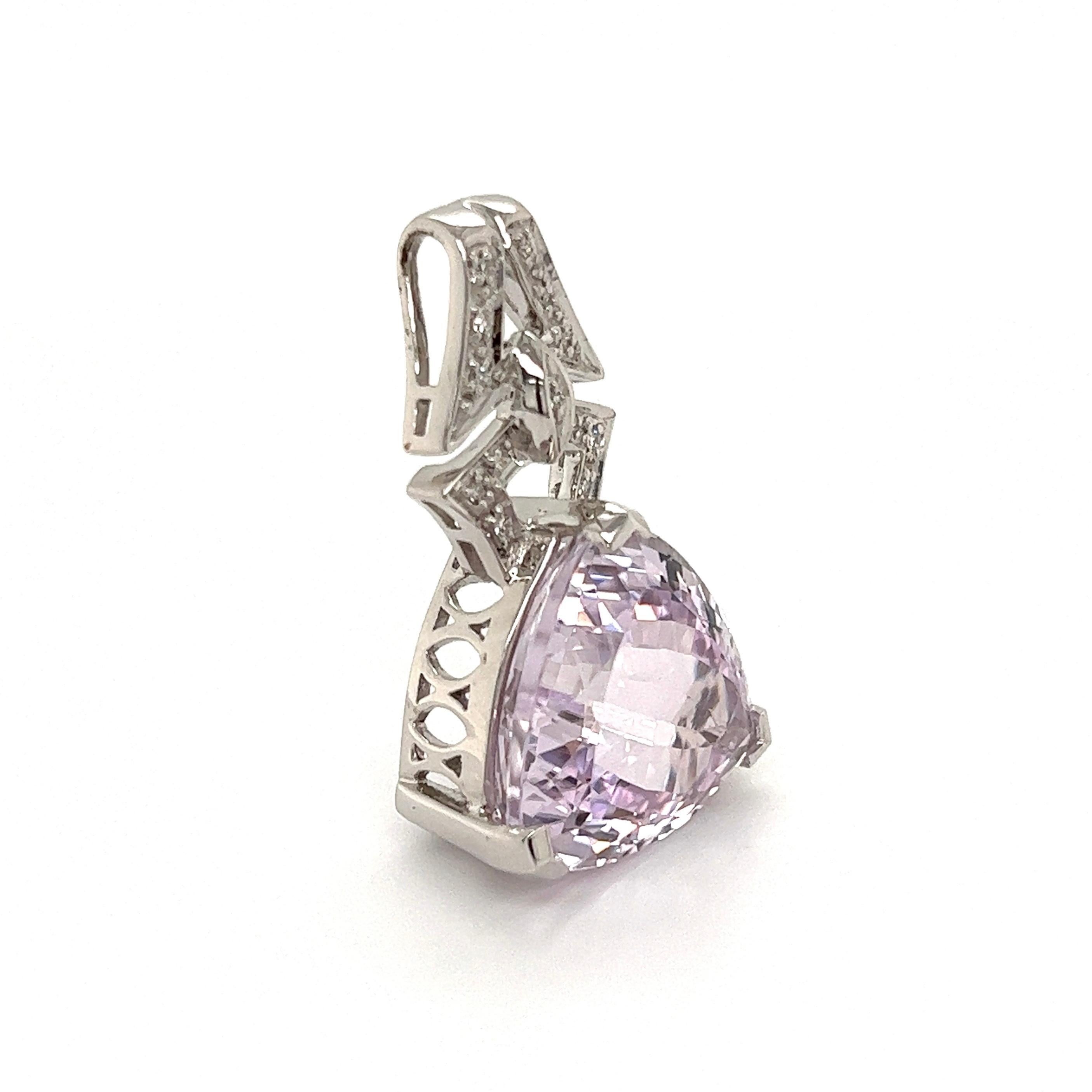 Exquisite 13.5 Carat Trillion Kunzite and Diamond Pendant Necklace. Accented with Diamonds, weighing approx. 0.19tcw. Beautifully Hand crafted 18K White Gold. Measuring approx. 1.25” H x 0.73” W. More Beautiful in real time! Chic and Timeless…Sure
