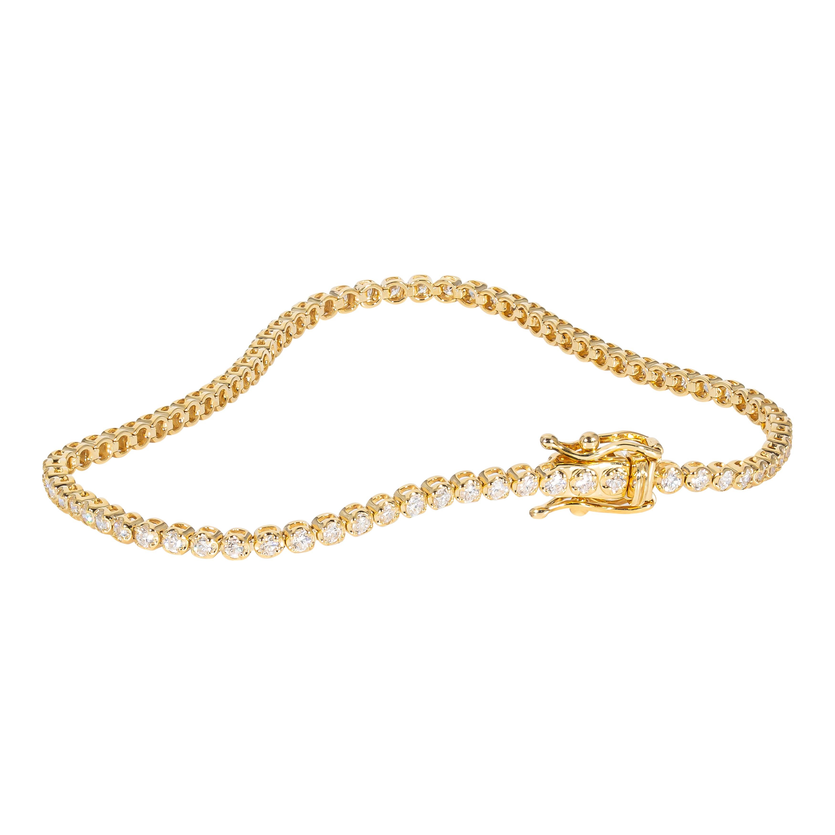14k yellow gold bracelet containing prong set natural diamonds. The total weight of the diamonds is 1.35 carats. The color and clarity grades of the diamonds contained within the bracelet have been graded by our Graduate Gemologists as E-F, VS1-SI1,