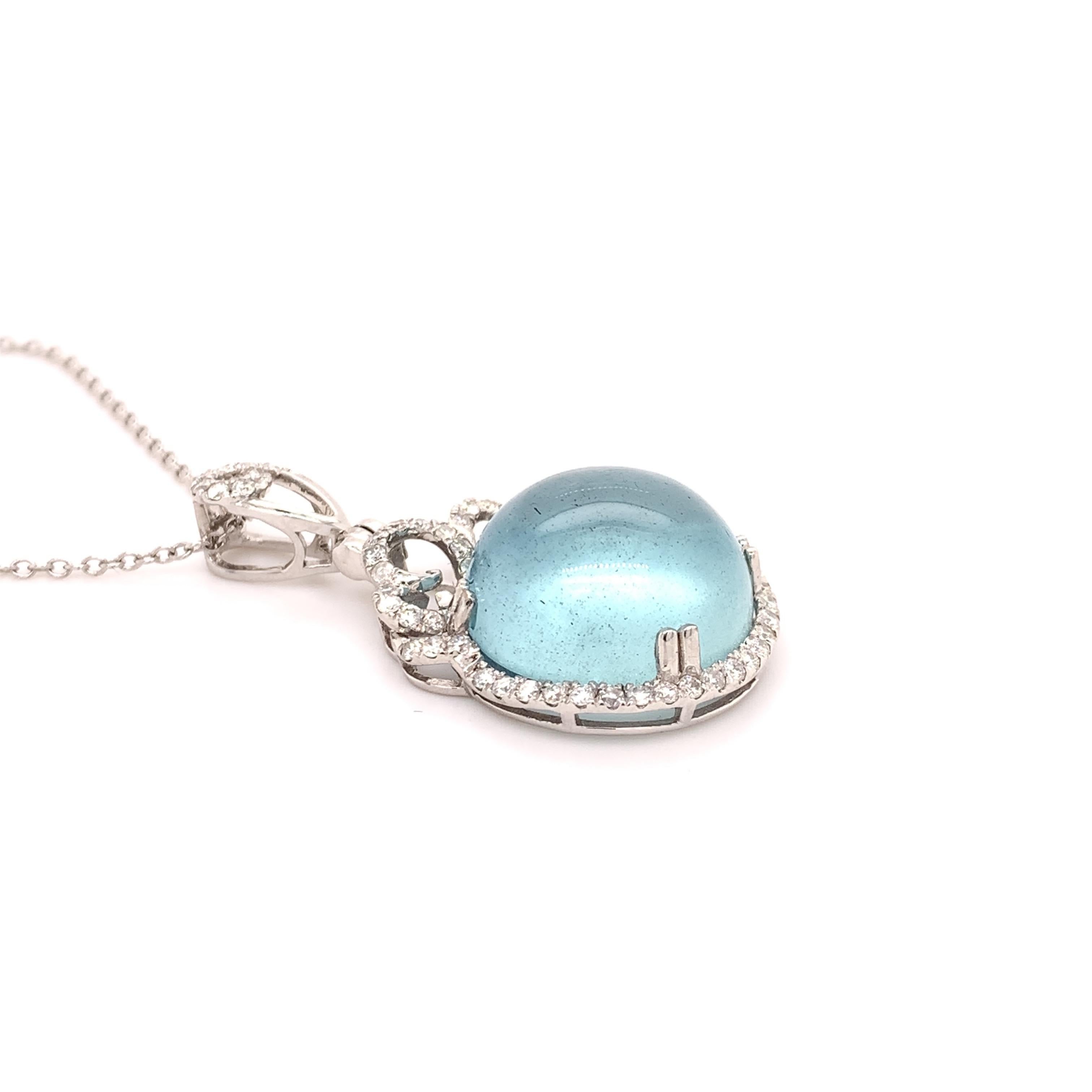 Unique aquamarine diamond pendant. Transparent clean, lively icy blue tone, round faceted, natural cabochon aquamarine  
set in high profile mounting with eight bead prongs, accented with round brilliant cut diamonds. Handcrafted design set in 14