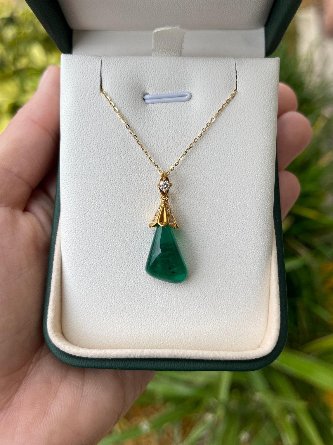 This one-of-a-kind emerald freeform baroque Muzo emerald pendant is a true vintage treasure, its organic silhouette resembling a mesmerizing droplet of water and green nature combined — a perfect symbol of our earthed raw beauty. Ethically mined,