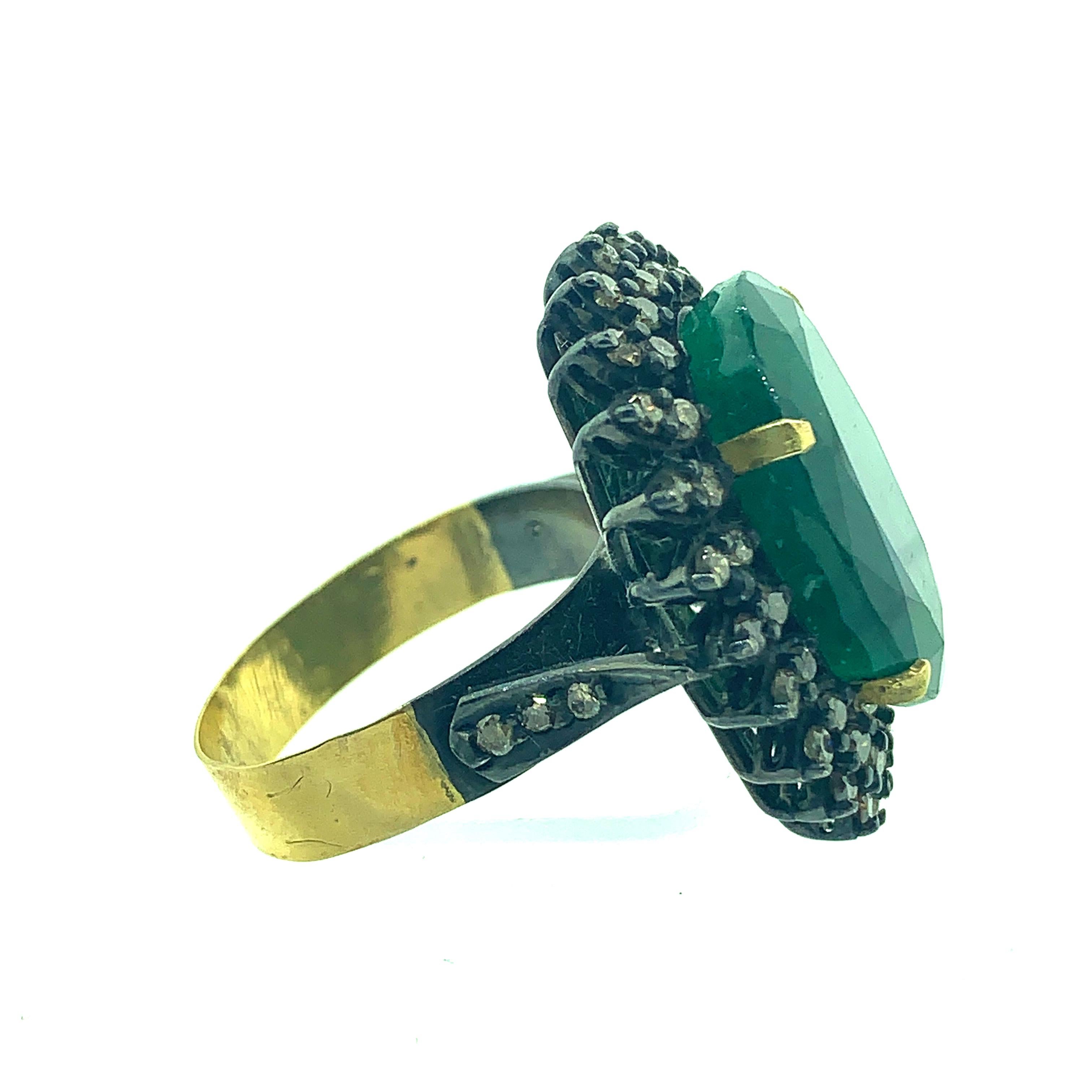 13.50 ct Emerald surrounded by 0.64 ct Champagne Diamond Ring set in Oxidized Sterling Silver with half shank and prongs in 18K Gold. The stones are all natural and real. The ring shank is 7 and it can be sized. 
Stones - Emerald : 13.50ct
         