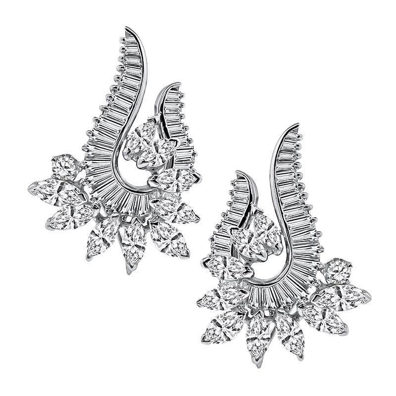 This is a stunning pair of 14k white gold night and day earrings. The earrings feature sparkling pear shape diamonds that weigh approximately 5.50ct. The color of the diamonds is F-G with SI2-I1 clarity. The pear shapes are accentuated by dazzling