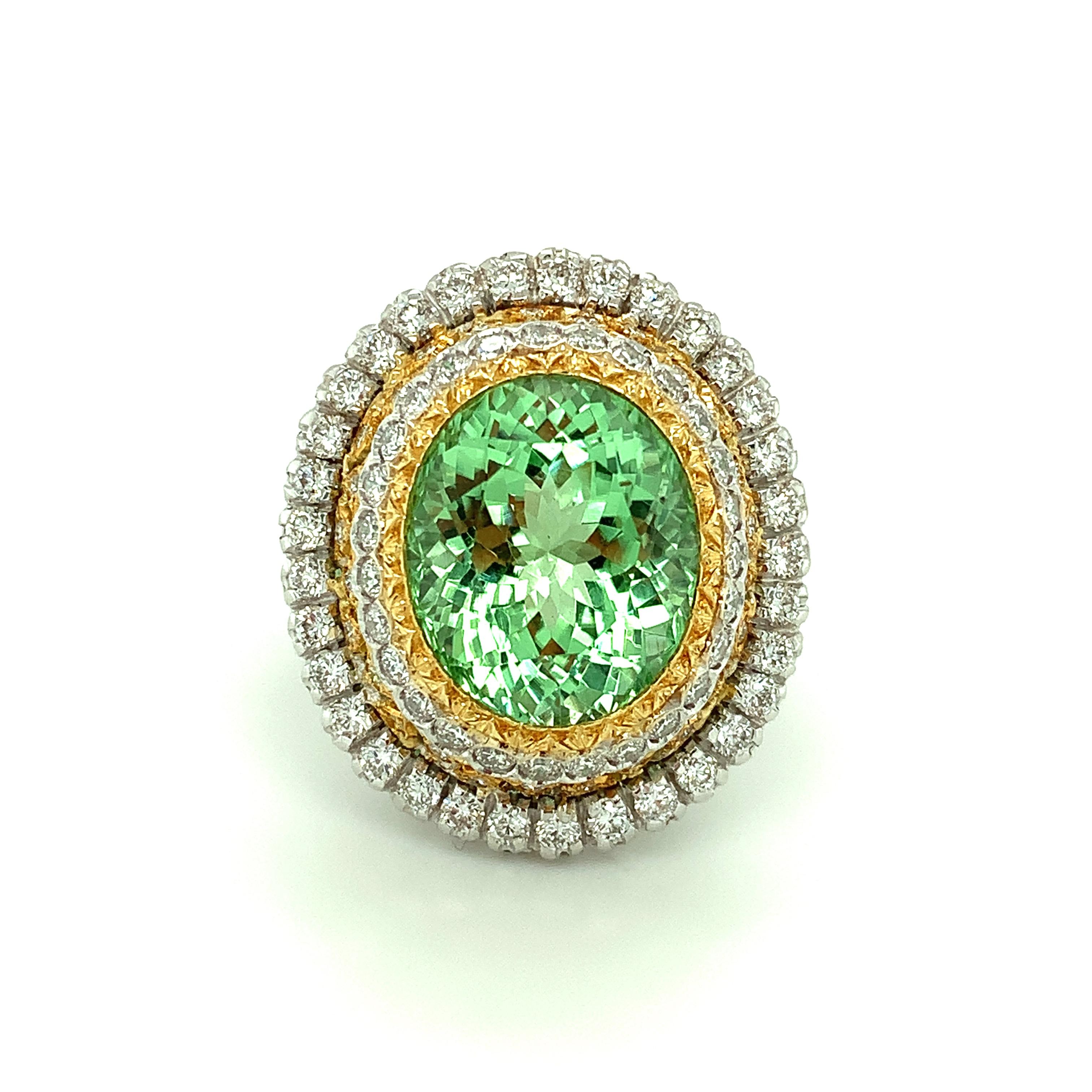 This beautifully handmade Italian ring features an exceptionally vibrant, 13.52 carat mint green tourmaline oval encircled by luxurious 18k gold and diamond halos! The tourmaline gemstone is a top-quality, crystalline beauty with exquisite mint