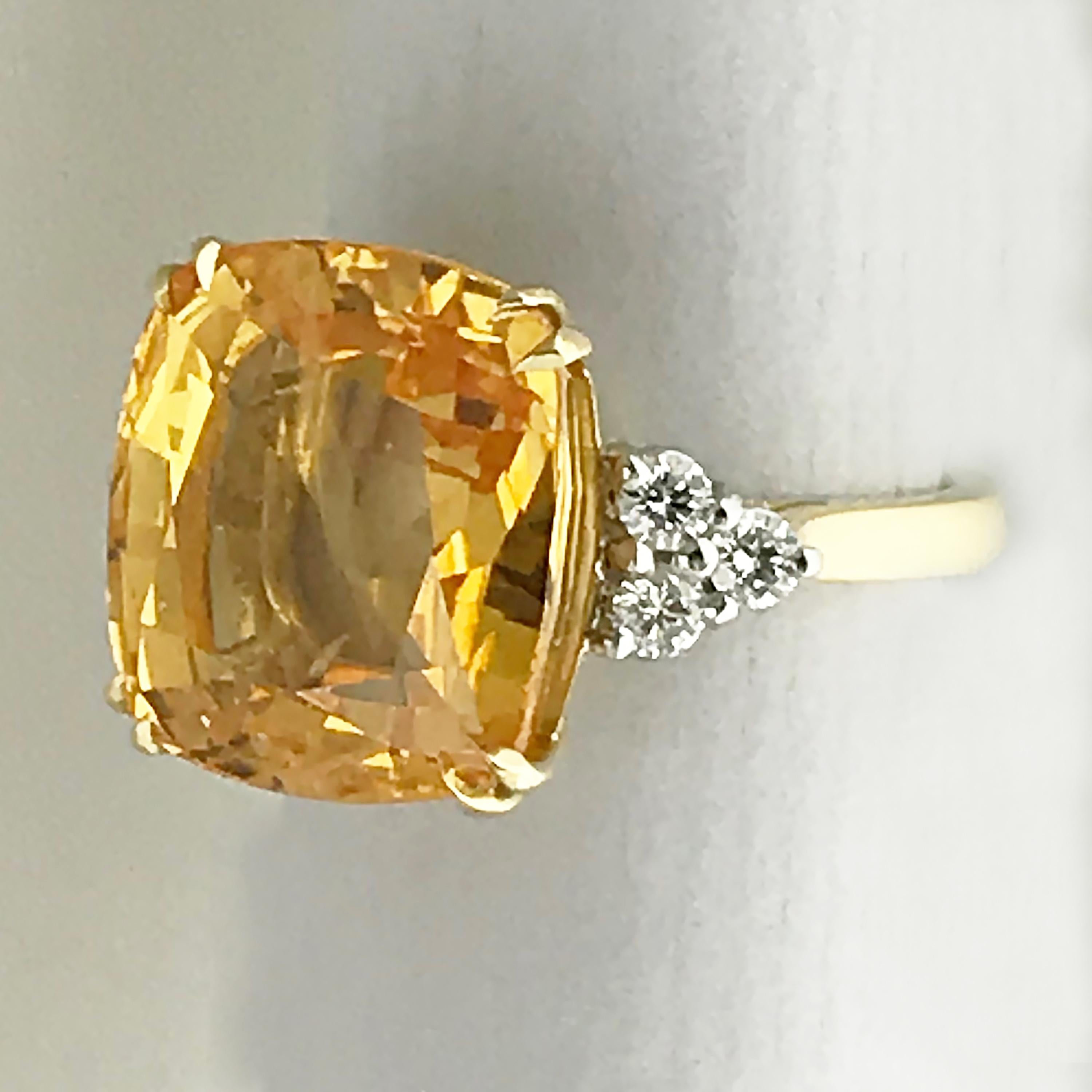 A rare natural colour, untreated, 13.55 carat cushion shape orange sapphire and diamond ring.

18ct yellow gold ring with three round brilliant diamonds on each shoulder G/H, Vs1-SI1, total weight approx 0.5ct.

Accompanied by GRS Gemresearch