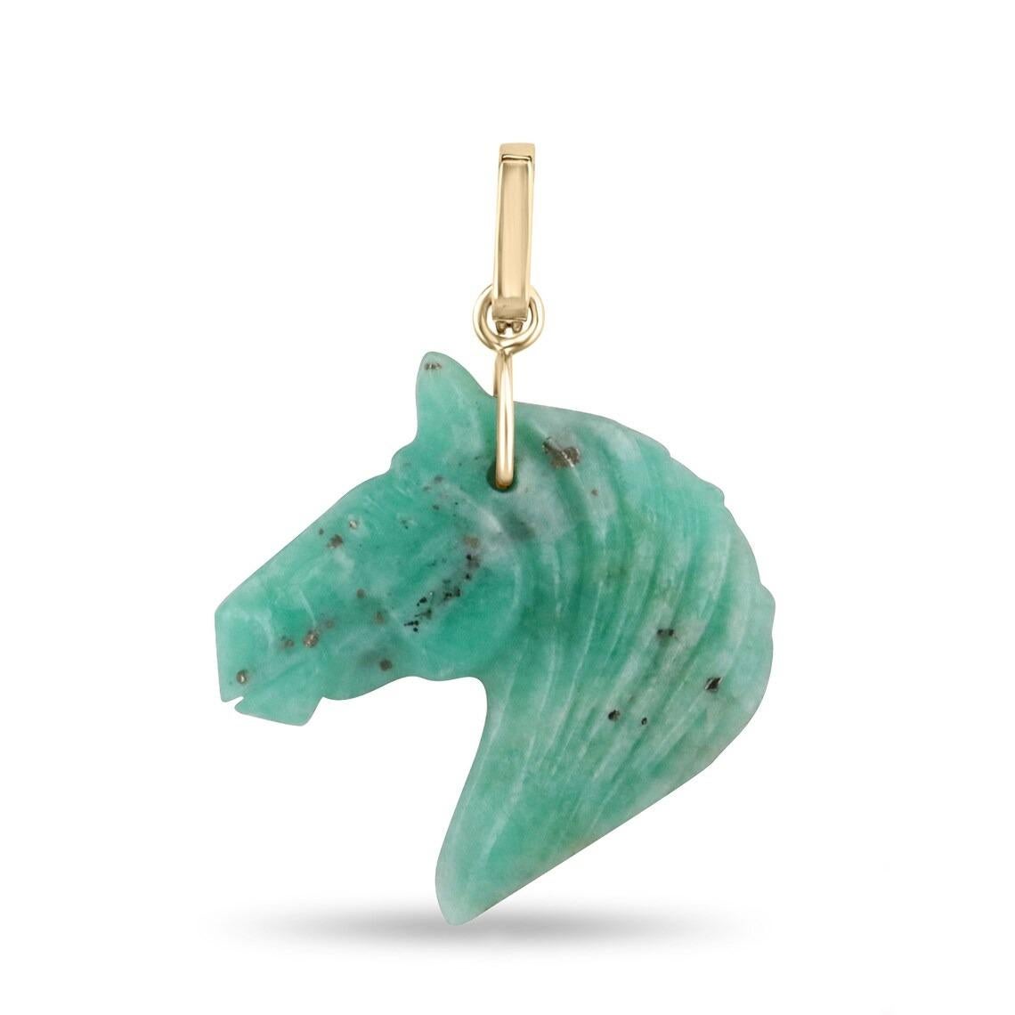 This exquisite hand-carved Colombian emerald rough horse sculpture showcases the raw beauty of emerald, accentuated by delicate touches of calcite, black shale, and gleaming pyrites gold. The horse's elegant side profile is adorned with a 14k gold