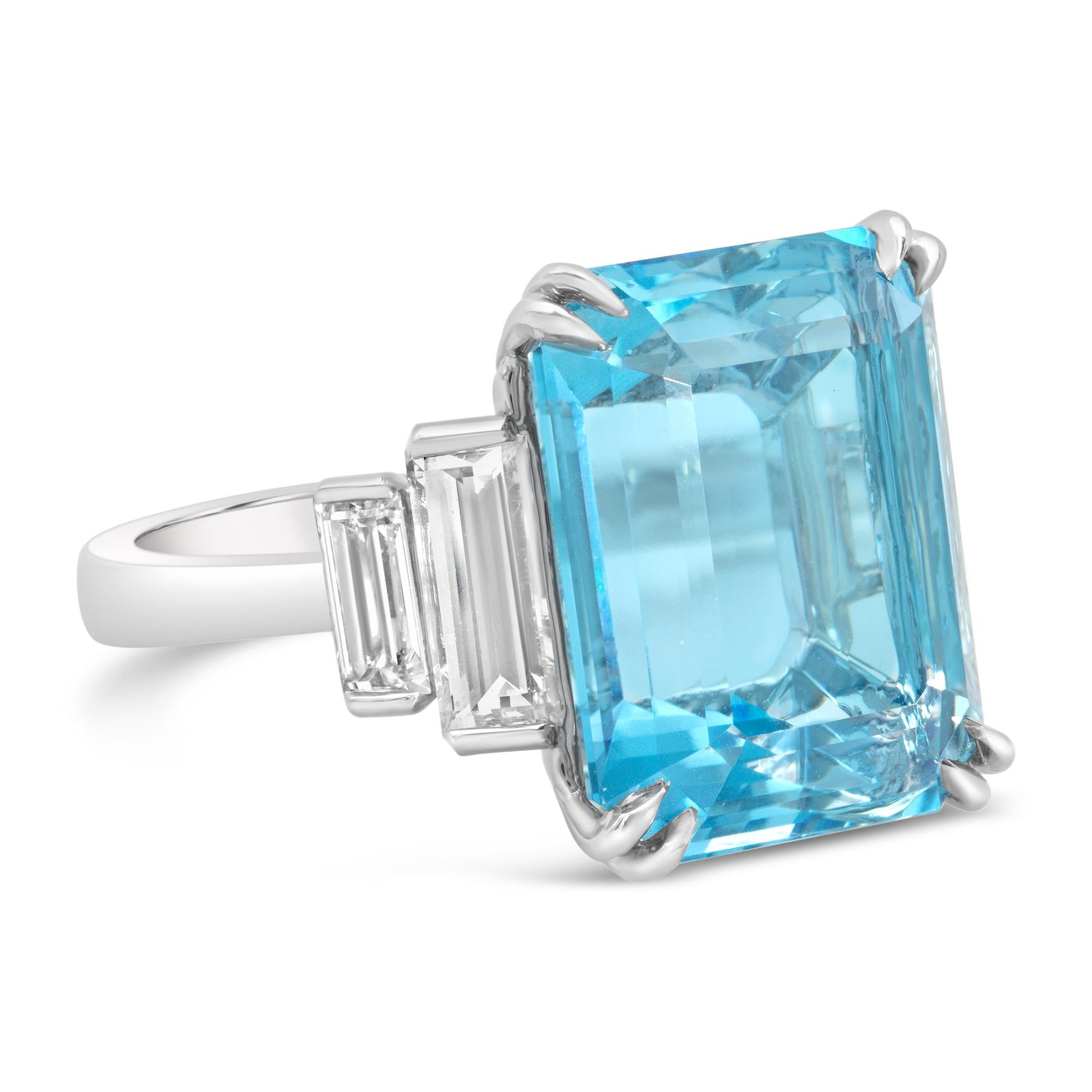 A gorgeous engagement ring, featuring a 13.58 carats emerald cut blue aquamarine, set on an eight prong setting. Flanked by four brilliant baguette cut diamonds weighing 1.87 carats total. Finely made with a platinum mounting. Size 6 US, resizable