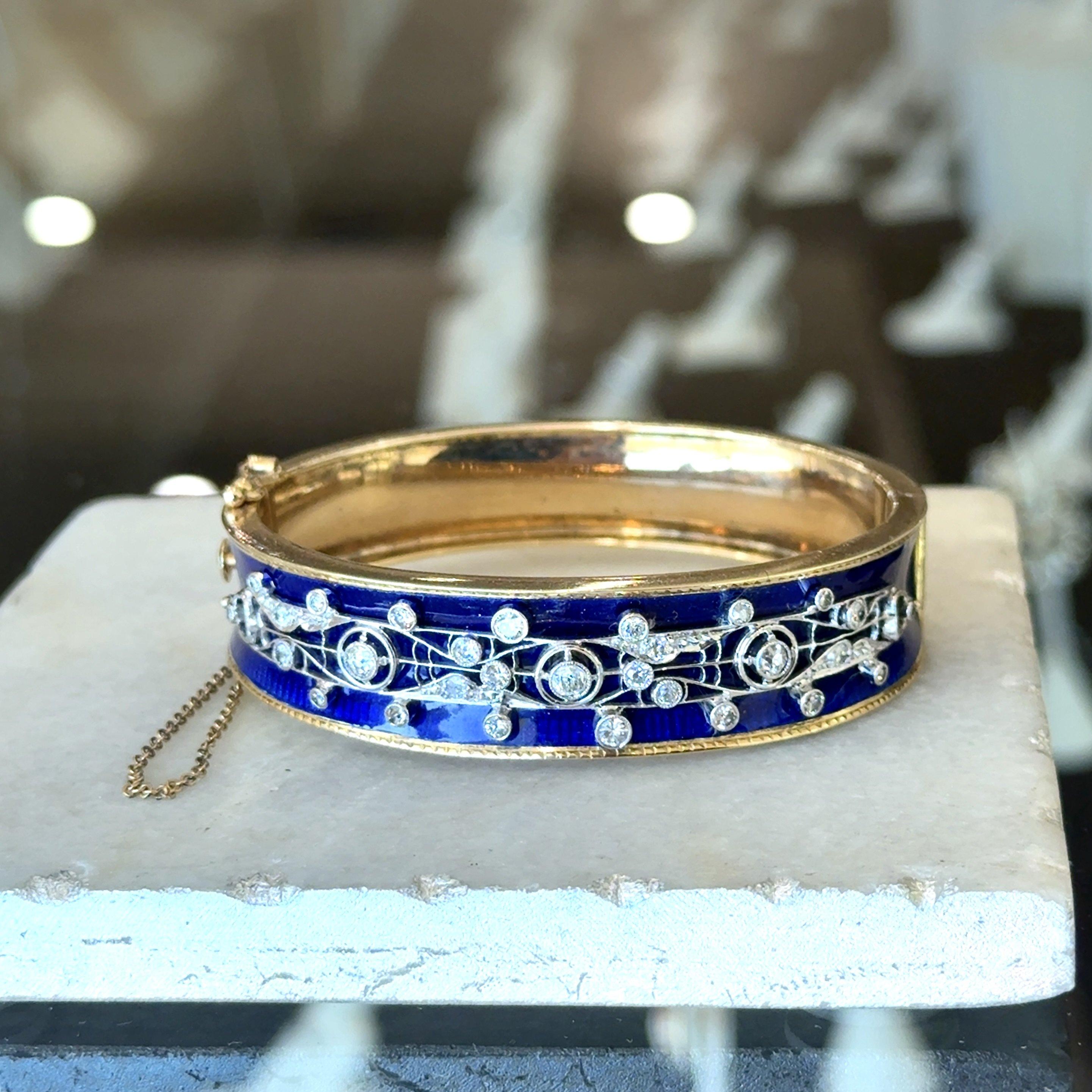 This Stunning Vintage Bangle Bracelet Dates from The 1940s.
 It’s Crafted in 14KT Yellow Gold with Beautiful Blue Enamel.
The Enamel is in Excellent Condition.
1.35ct of Beautiful Old European Cut and Old Mine Cut Diamonds.
F-H Color  VS-SI Clarity.