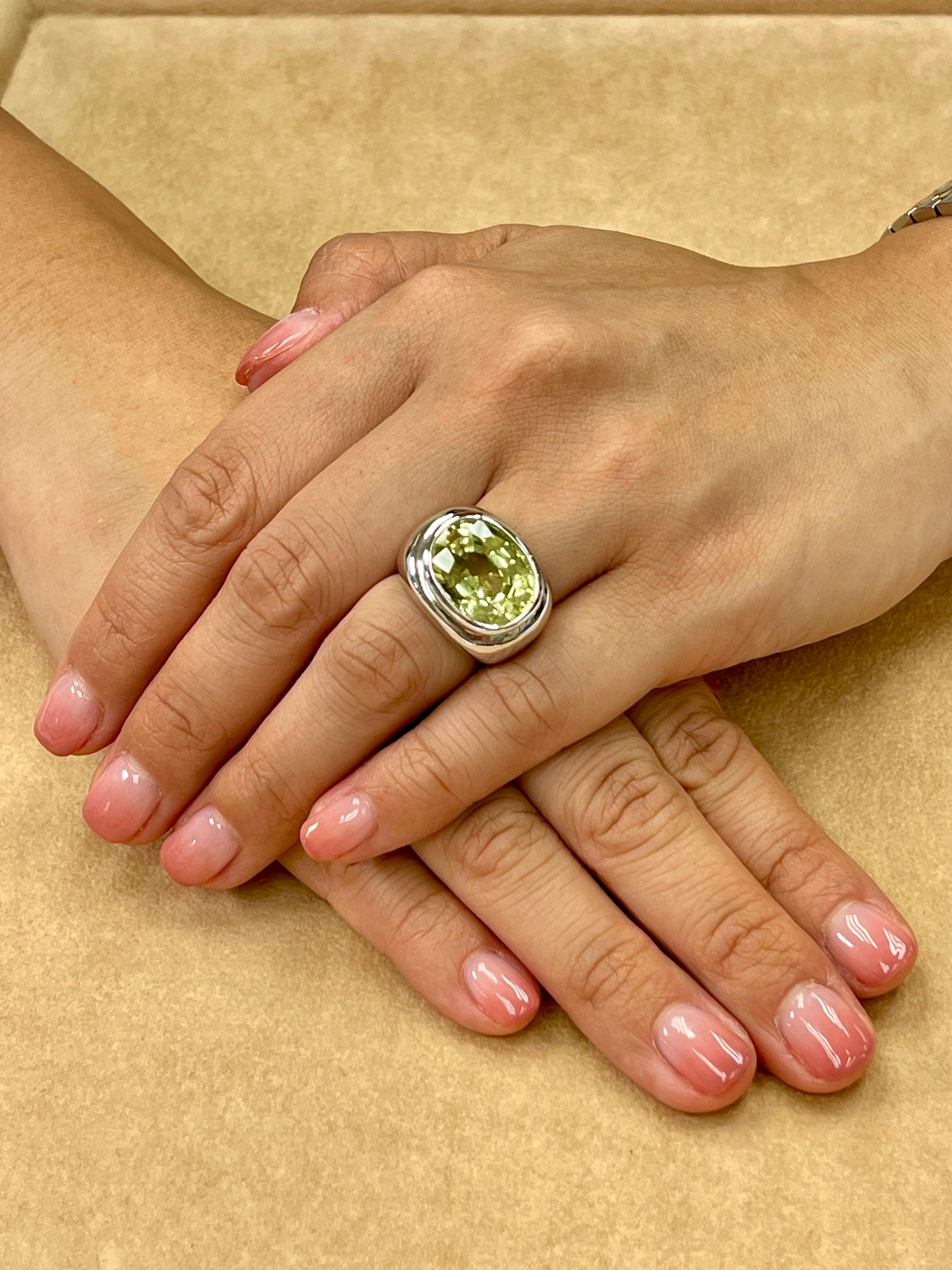 Please check out the HD video. New Old Stock. This is a unisex ring. The kunzite is a very nice yellow green! This Kuzite statement ring will get you tons of compliments. The center stone is about 13.5cts. The ring is set in solid 18k white gold.