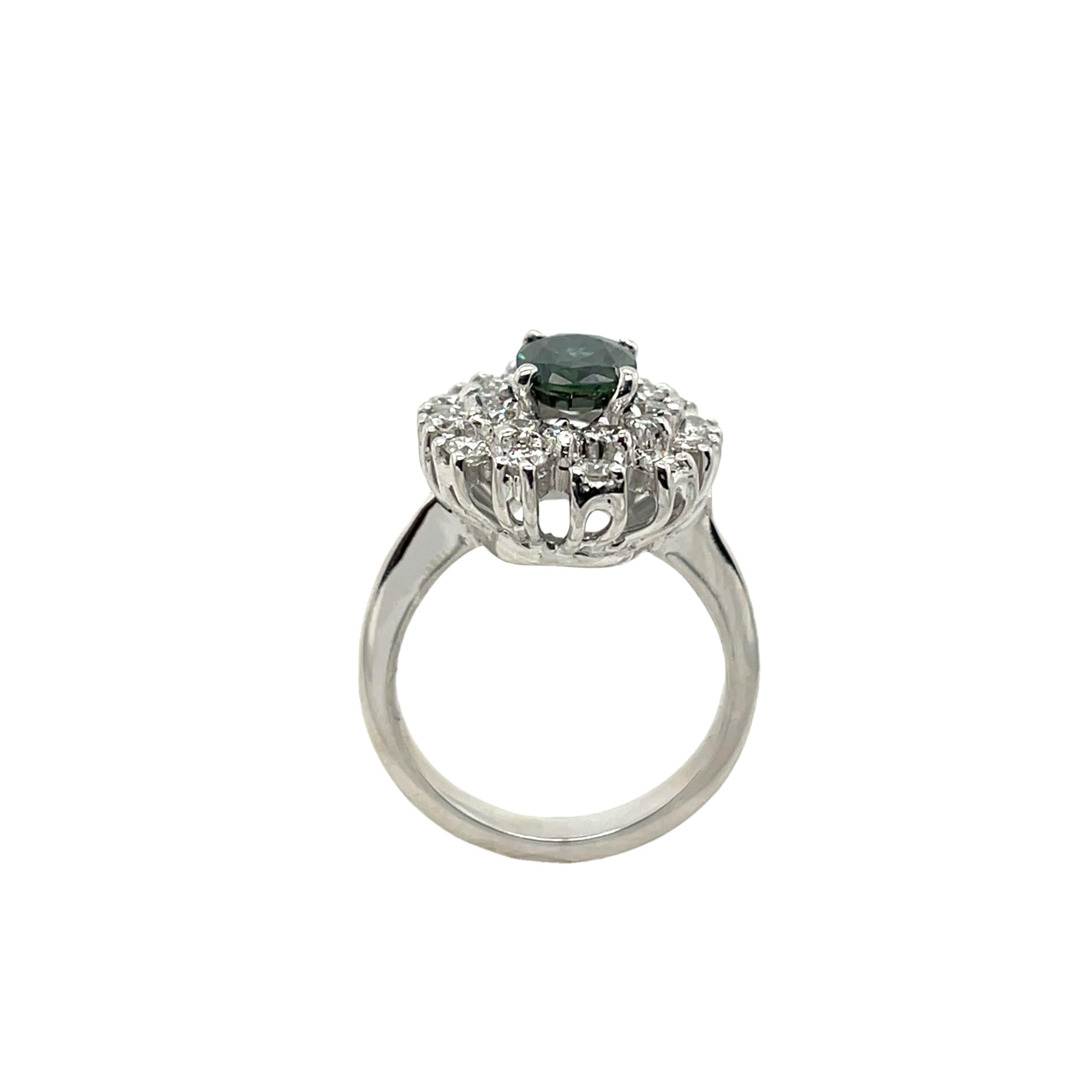 1.35ct green sapphire & 0.84ct diamond cluster ring set in luxurious 18ct white gold. This elegant ring features a vibrant green sapphire at its center, encircled by a halo of sparkling natural diamonds for a classic and refined look.
Total Diamond
