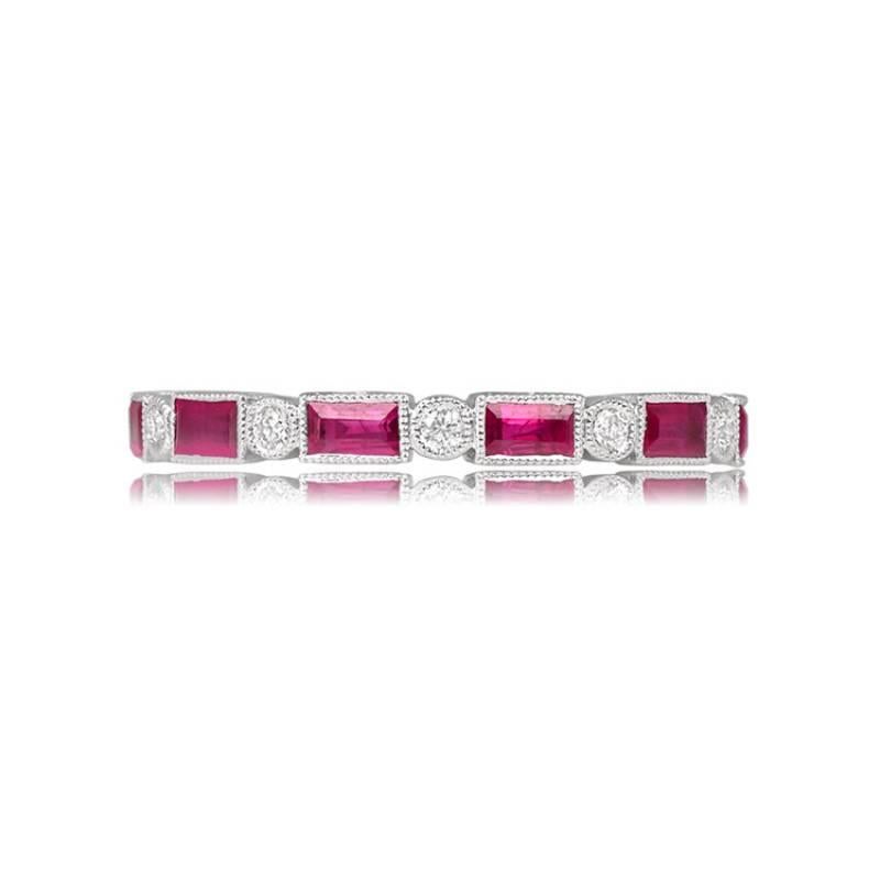 An elegant 18k white gold wedding band adorned with bezel-set baguette-cut natural rubies, totaling 1.35 carats, and round brilliant diamonds with a combined weight of 0.15 carats. The band, measuring 2.44mm in width, is intricately designed with