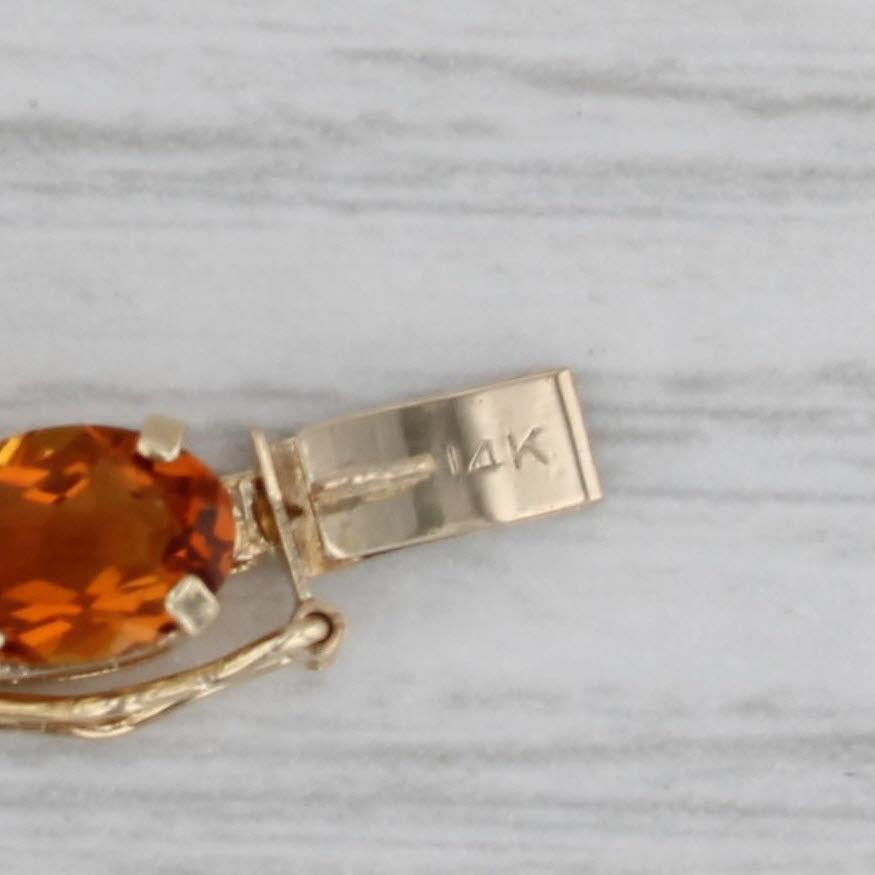 Gemstone Information:
- Natural Citrine -
Total Carats - 10.50ctw
Cut - Oval
Color - Orange
Treatment - Heated

- Natural Peridots -
Total Carats - 3ctw
Cut - Oval Brilliant
Color - Light Green

Metal: 14k Yellow Gold
Weight: 7.6 Grams 
Stamps: