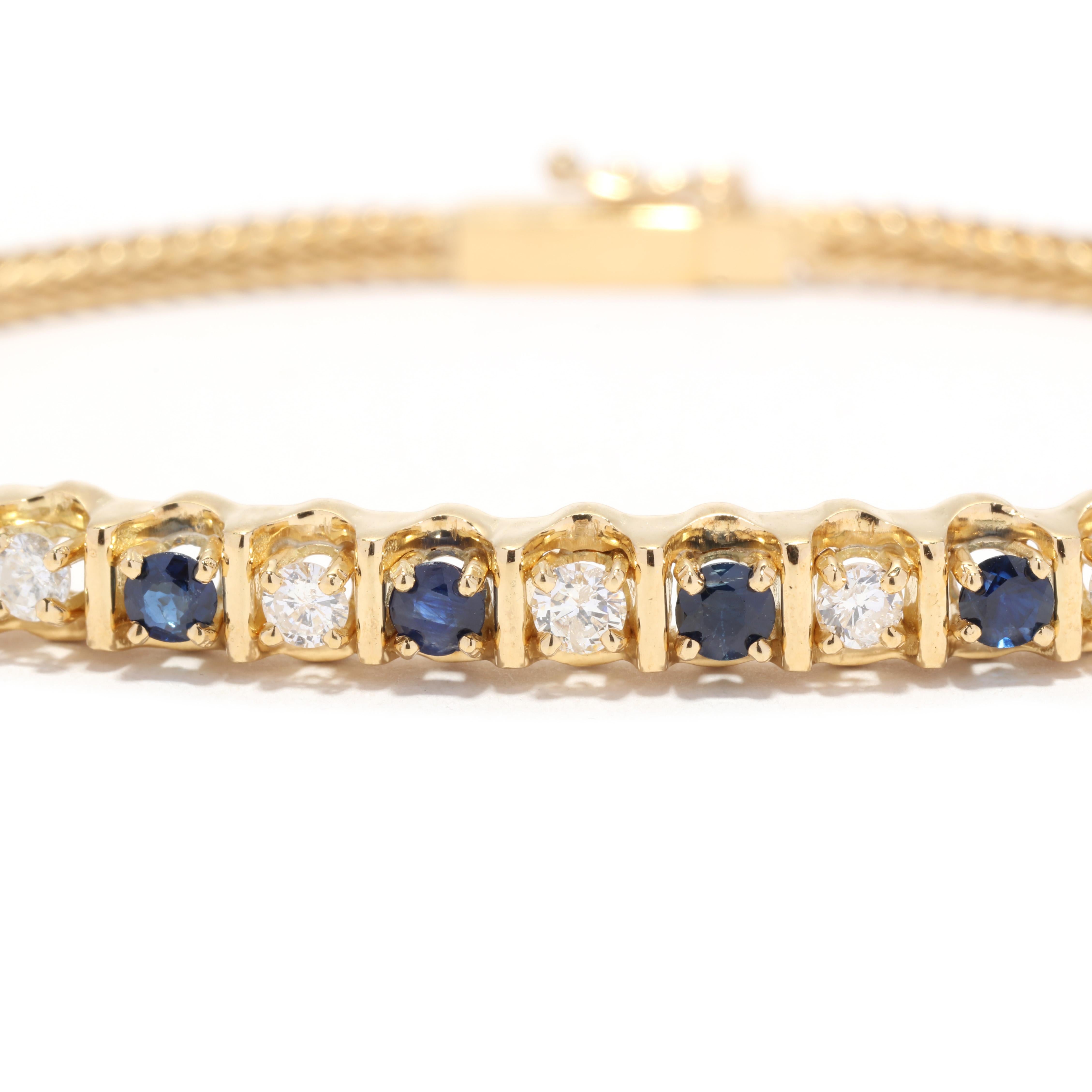 A vintage 18 karat yellow gold diamond and sapphire bar bracelet. This stackable bracelet  features a bar station set with alternating round cut sapphires weighing approximately .80 total carats and round brilliant cut diamonds weighing