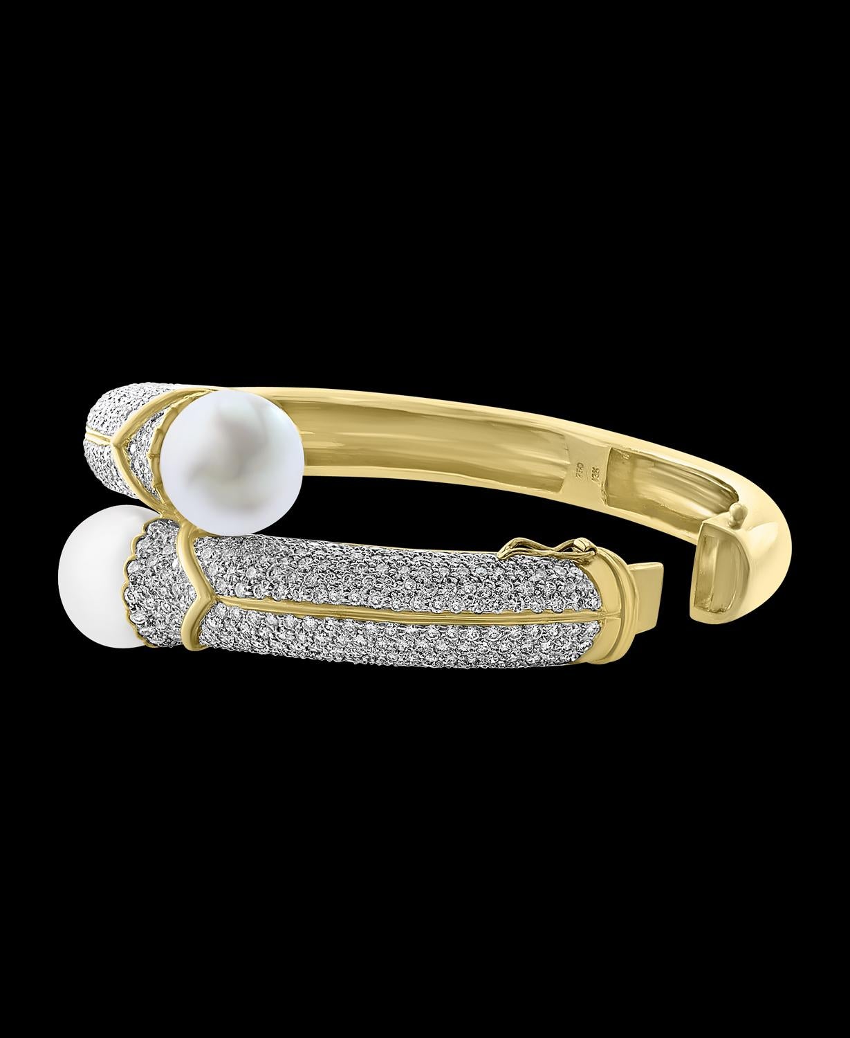 Two South Sea Pearl  Each 13.5 mm And  8 Ct Diamond  Bangle in 18 Karat Yellow Gold Estate
Diamonds : Approximately 8 Carat
South sea Pearlm : Each Pearl high Luster , White , No Blemishes , 13.5mm in size 
18k Yellow  gold  : 66 Grams
open from