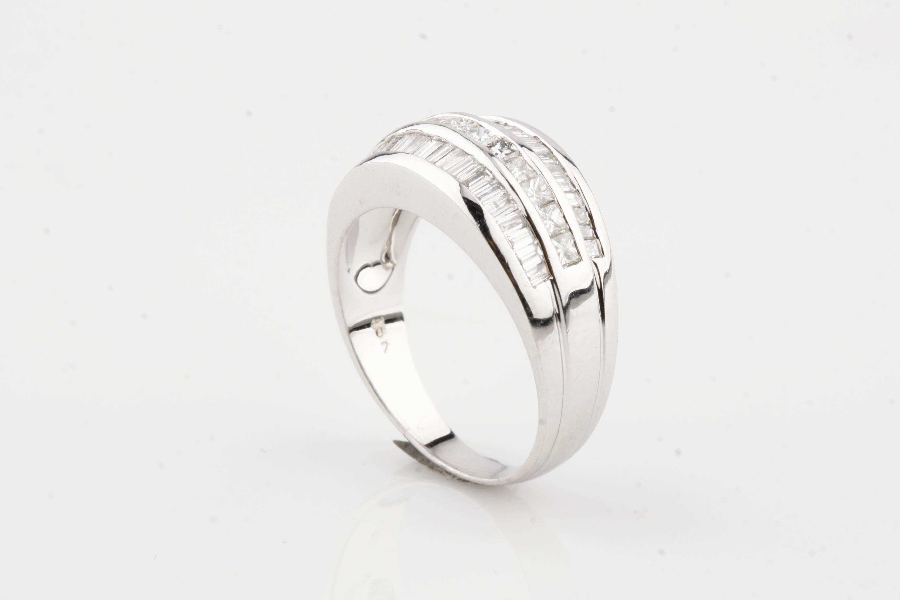 Gorgeous Band Ring
Features Three Rows of Channel Set Stones
Princess Cut Row in Middle Flanked by Two Rows of Baguettes
Total Diamond Weight = 1.36 ct
Size 6.75
Width of Front = 9 mm
Width of Band at Back = 3 mm
Total Mass = 5.7 hrams
Gorgeous Gift!