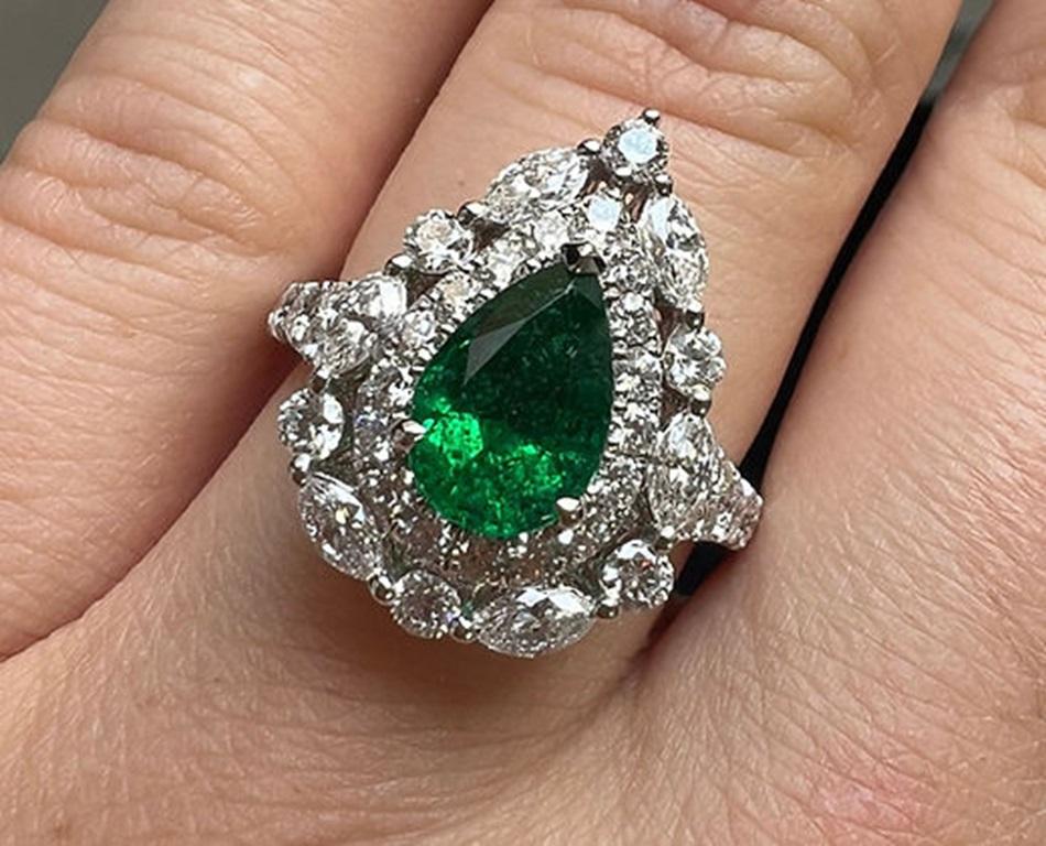 Emerald Weight: 1.36 CT, Diamond Weight: 1.48 CT, Metal: 18K White Gold, Gold Weight: 5.56 gm, Ring Size: 6.5, Shape: Pear, Color: Intense Green, Hardness: 7.5-8, Birthstone: May