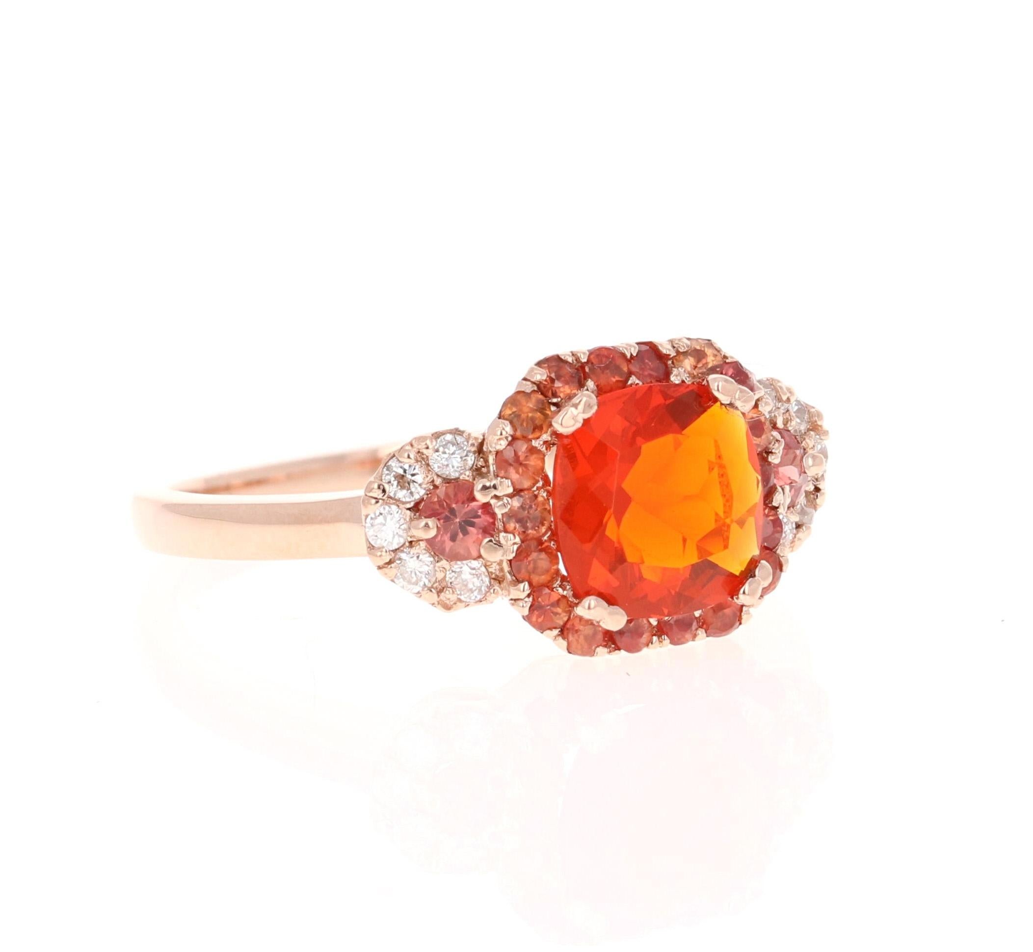 Beautiful Fire Opal and Diamond Ring. This ring has a 0.78 carat Cushion Cut Fire Opal in the center of the ring and is surrounded by a halo of 20 Orange and Red Sapphires that weigh a total of 0.46 carats and there are 10 Round Cut Diamonds that