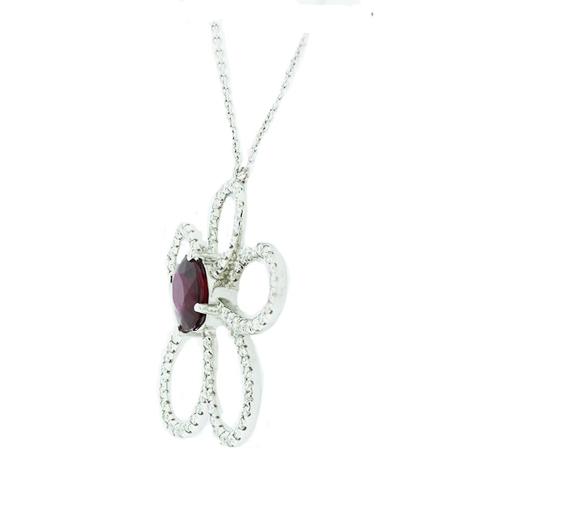 Quality Ruby Floral Shaped Pendant showcases an oval shaped center stone measuring 7.43 x 6.21 x 3.65 mm. The ruby weight is 1.36 carat.
Encrusted diamond 18 karat white gold setting, shaped as a flower and consists of 92 round brilliant stones. The