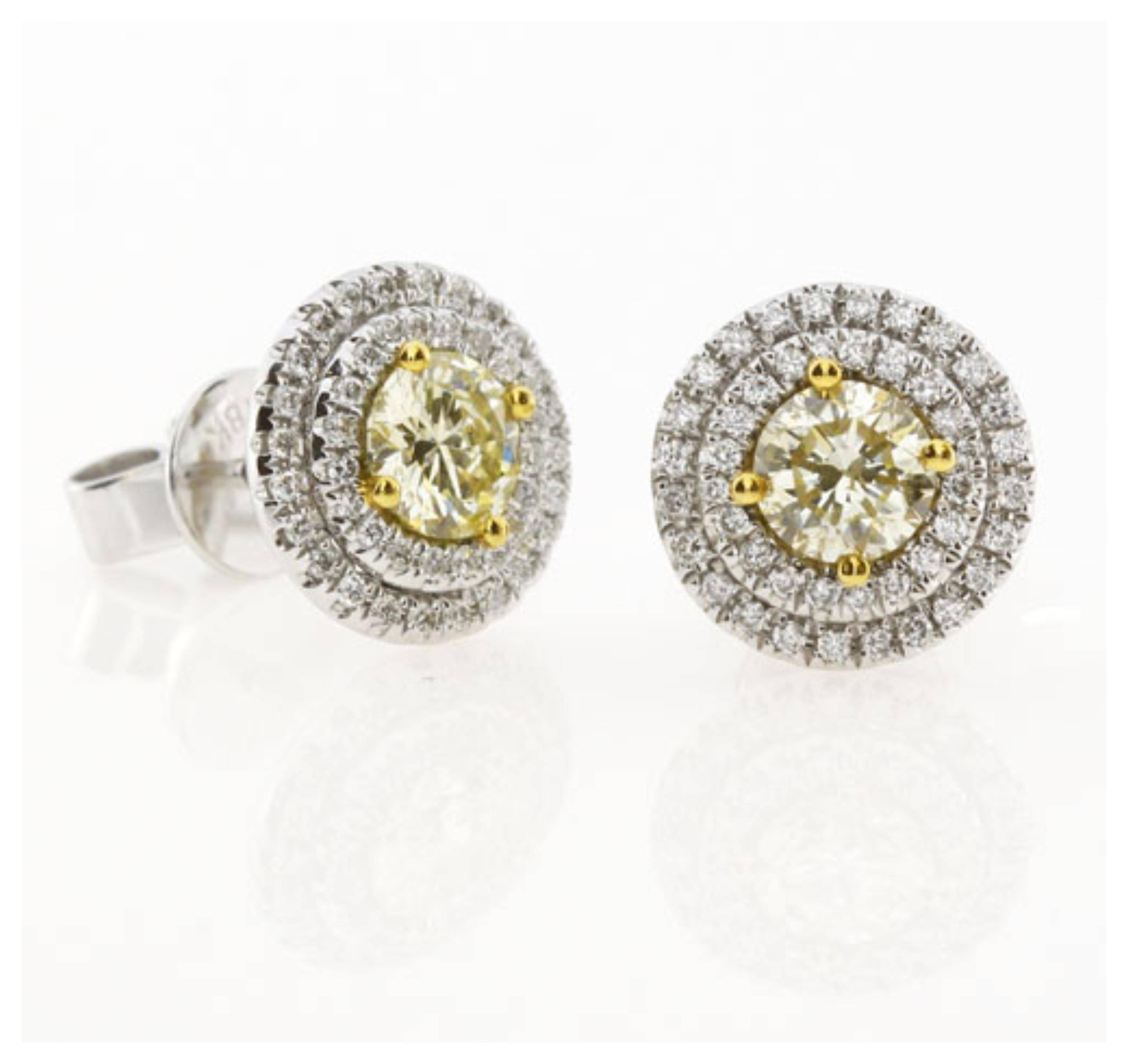 1.00 Carat Natural Fancy Yellow Diamond Stud Earrings featuring two round Natural Fancy Yellow Diamonds (.51 Carat each) surrounded by two rows of accent white diamonds. 
Total Carat Weight: 1.36 Carat
Yellow Diamonds: 1.02 Carat (total 2