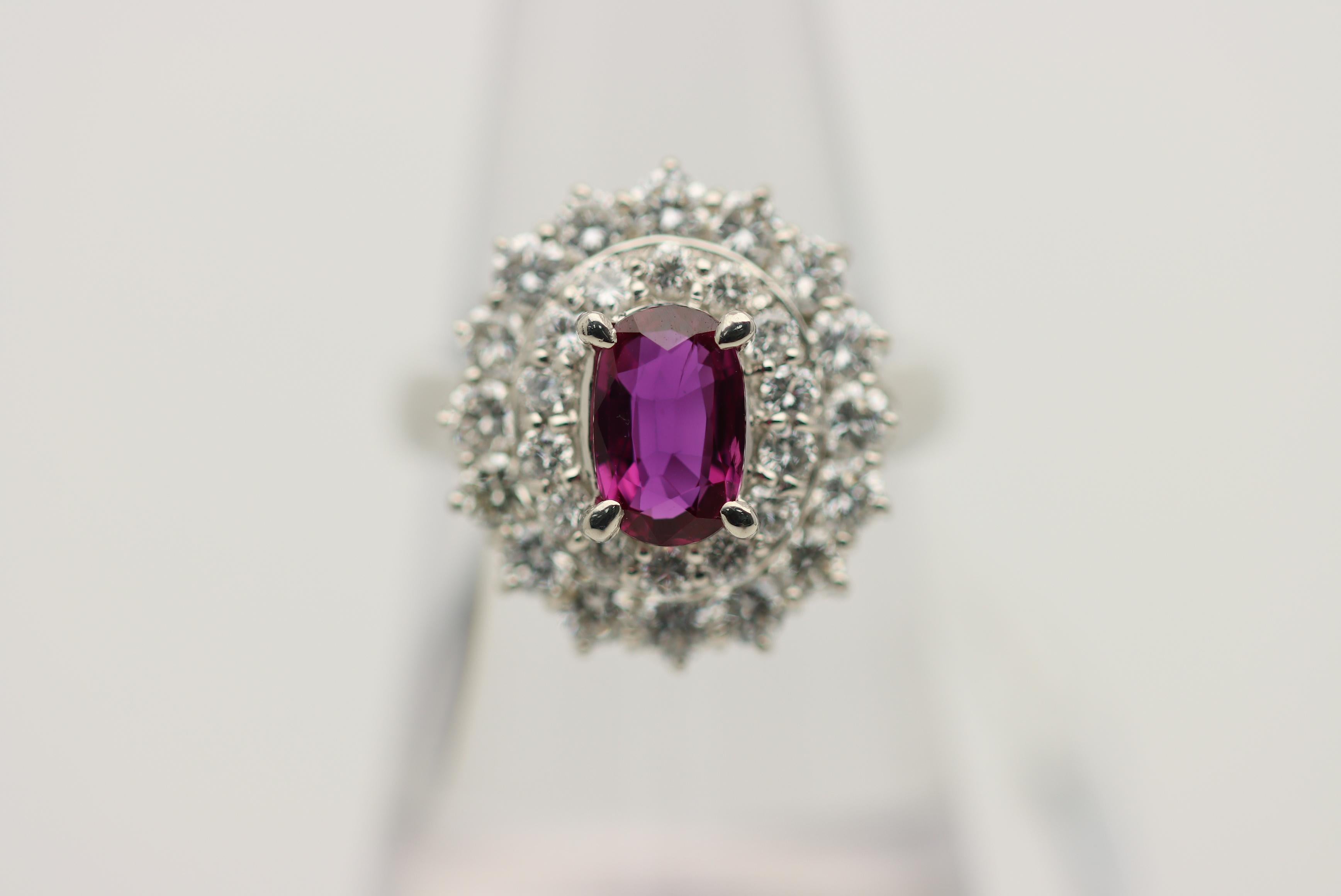 A fine platinum ring featuring a beautiful richly colored purplish-red color weighing 1.36 carats. Adding to that, the ruby is eye-clean with no visible inclusions allowing for great light return and brilliance. It is complemented by 1.62 carats of