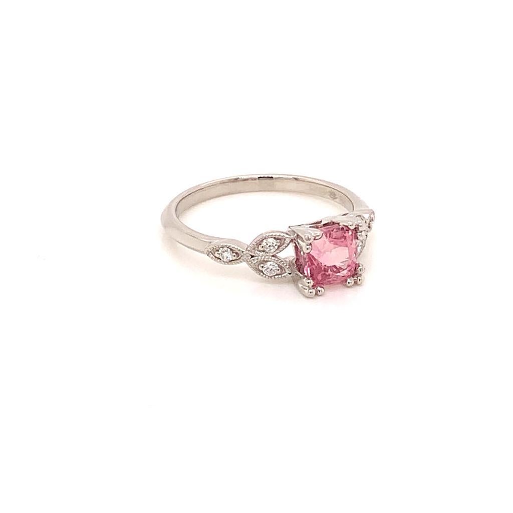 The centre stone of this elegant ring is a Square Modified GCS Certified Natural Padparadscha Sapphire, a rare find among the vast collection of sapphires. Set in Platinum, with glittering Round Brilliant Diamonds in an intricate setting alongside