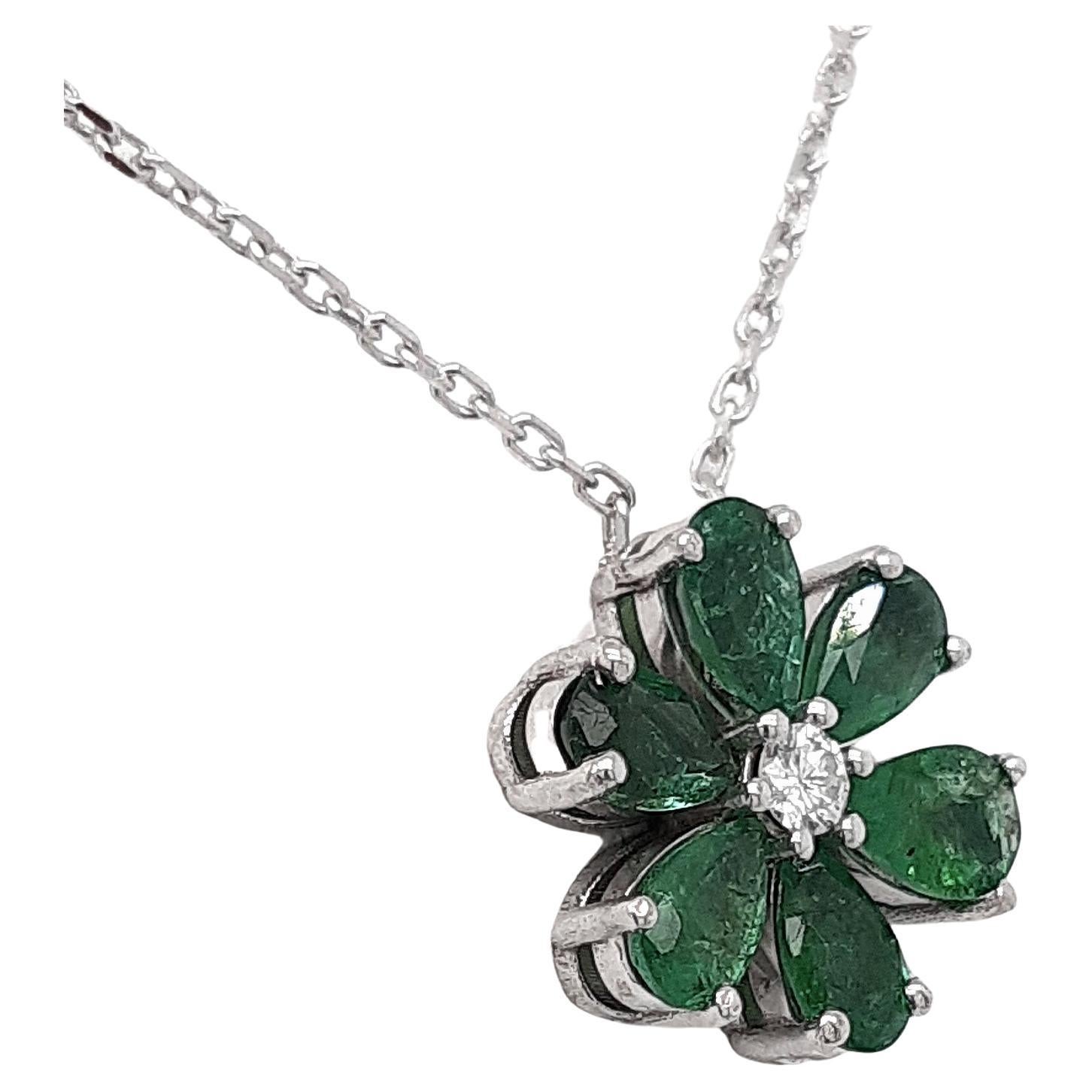 FOR U.S. BUYERS NO VAT 

In this breathtaking 14kt white gold pendant, 6 gorgeous green pear shape mixed cut emeralds totaling 1.30 are surrounding one round brilliant cut white colorless diamond weighing 0.06 carats in such a way that they are