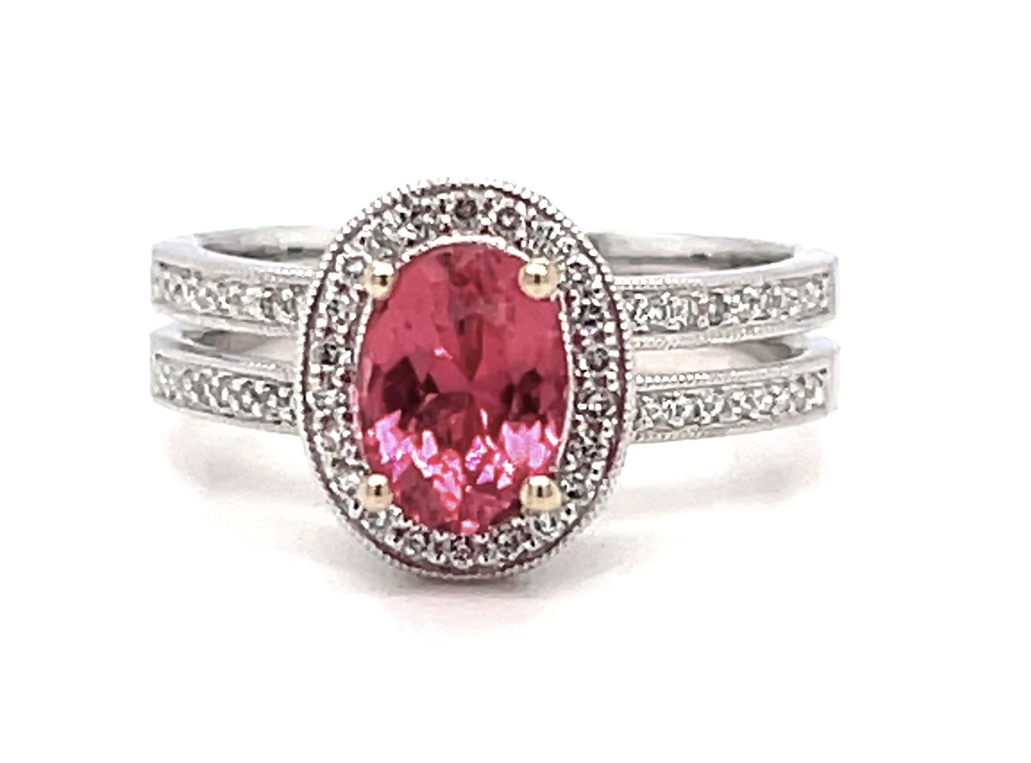 This beautiful 18k white gold ring features a spectacular hot pink spinel surrounded by a halo of brilliant round diamonds. The split band, set with sparkling diamonds, gives the ring a delicate and feminine look, while offering the comfort and
